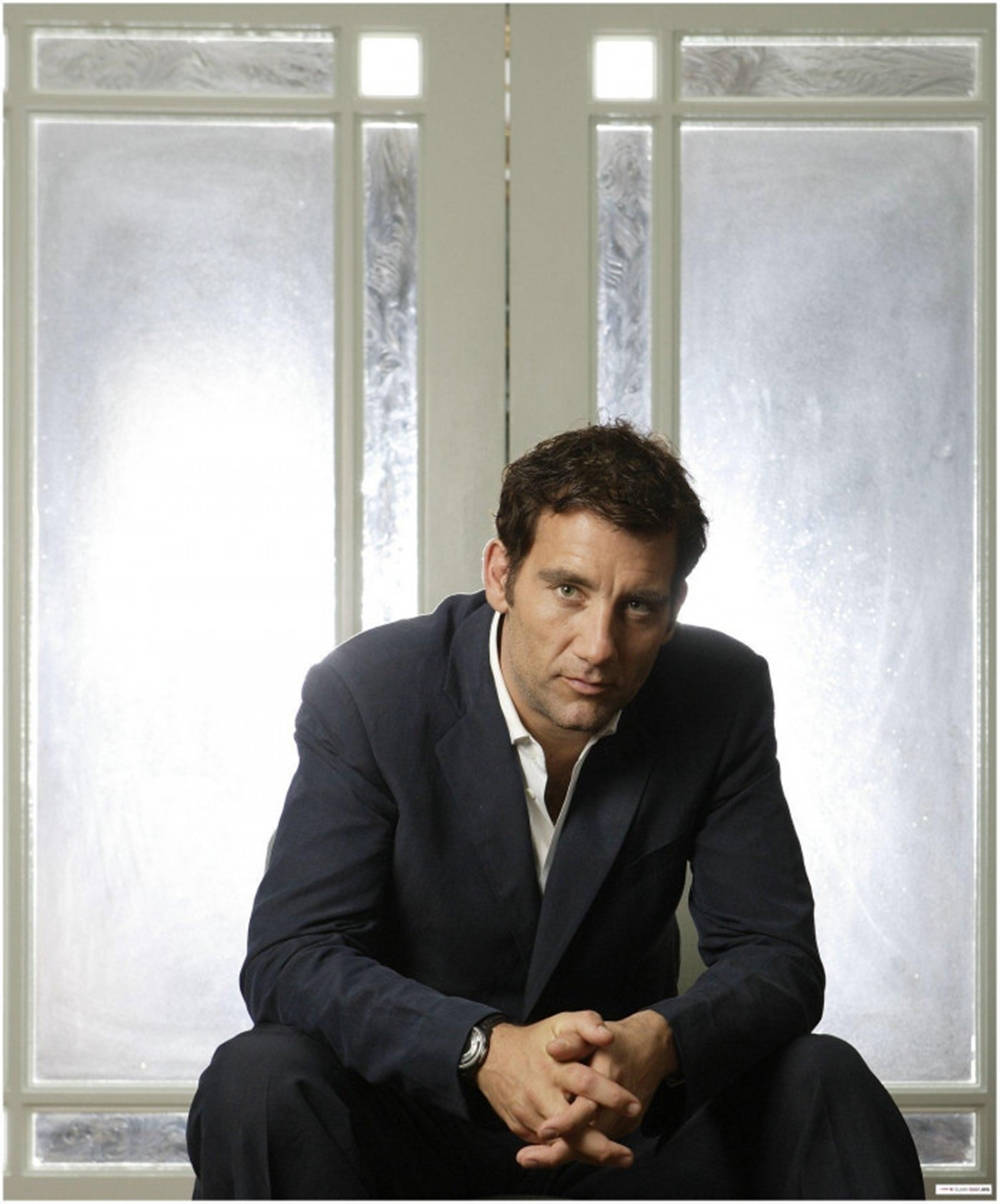 A Reflective Clive Owen Staring Out Of The Window