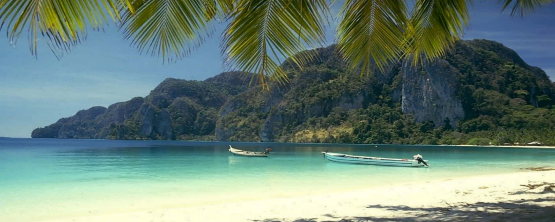 A Remote Work Haven - Find Your Productivity Paradise At The Beach With Dual Monitors Background