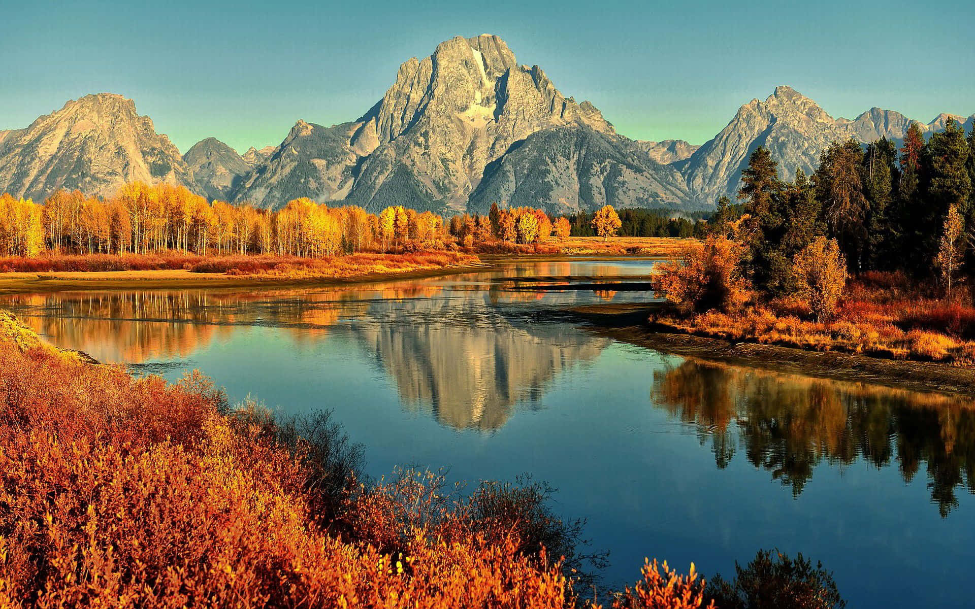 A River Surrounded By Mountains Background
