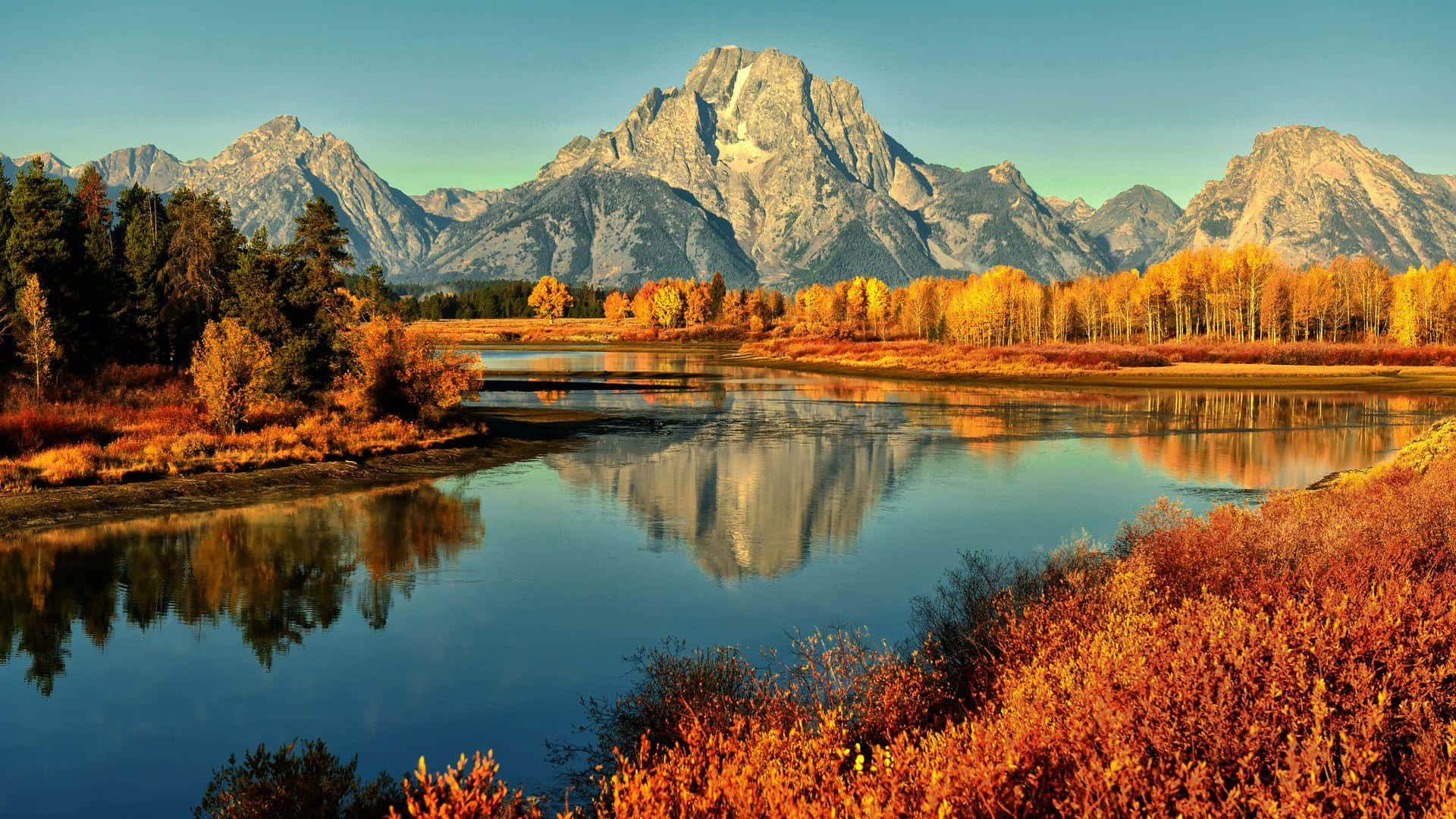 A River Surrounded By Mountains Background