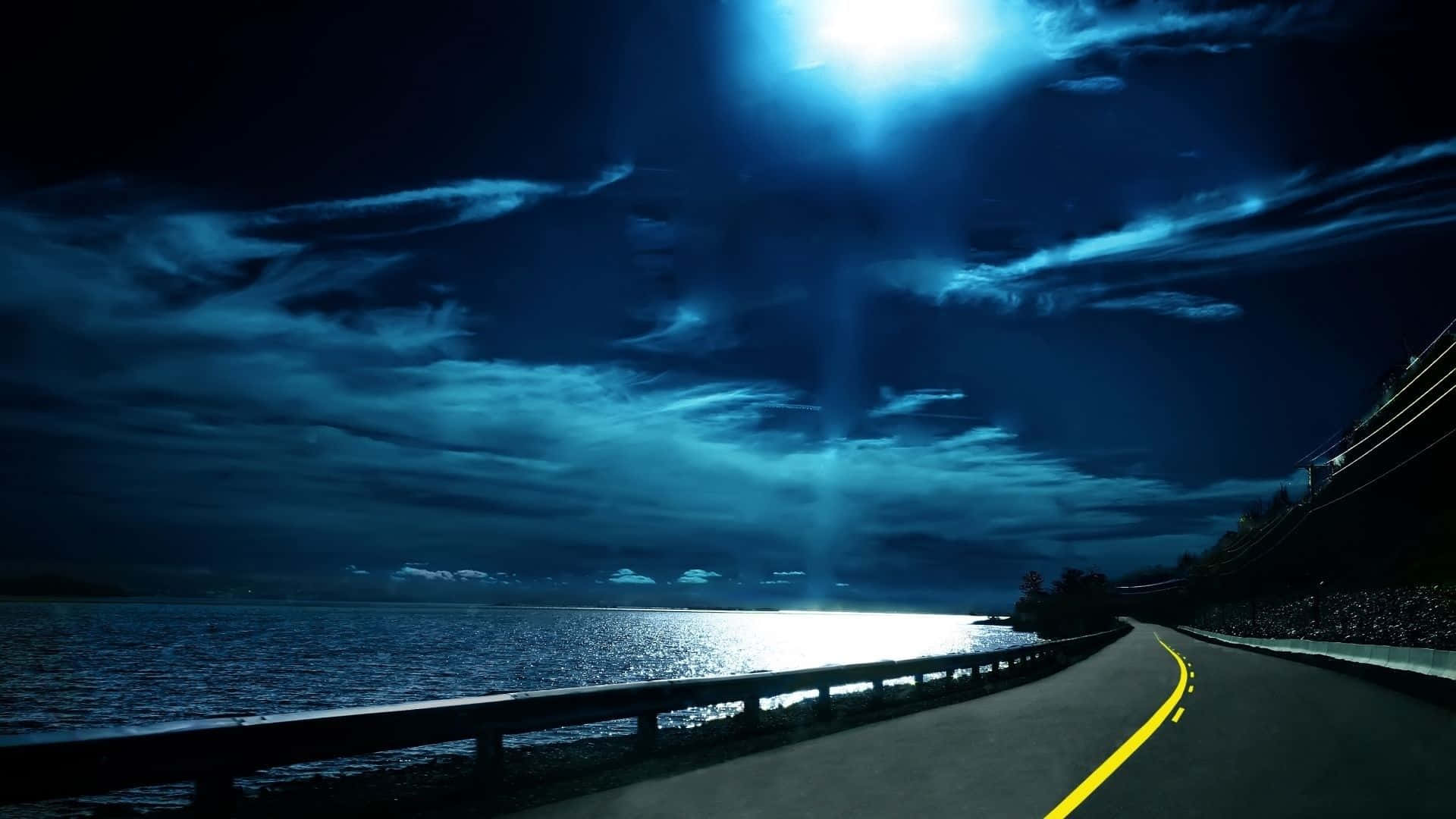 A Road With A Bright Moon Shining Over The Water Background