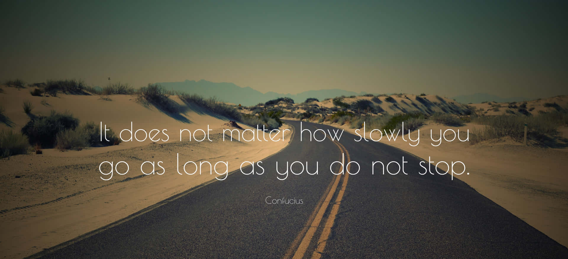 A Road With A Quote Saying Does Not Matter How You Go As Long As You Do Not Stop Background