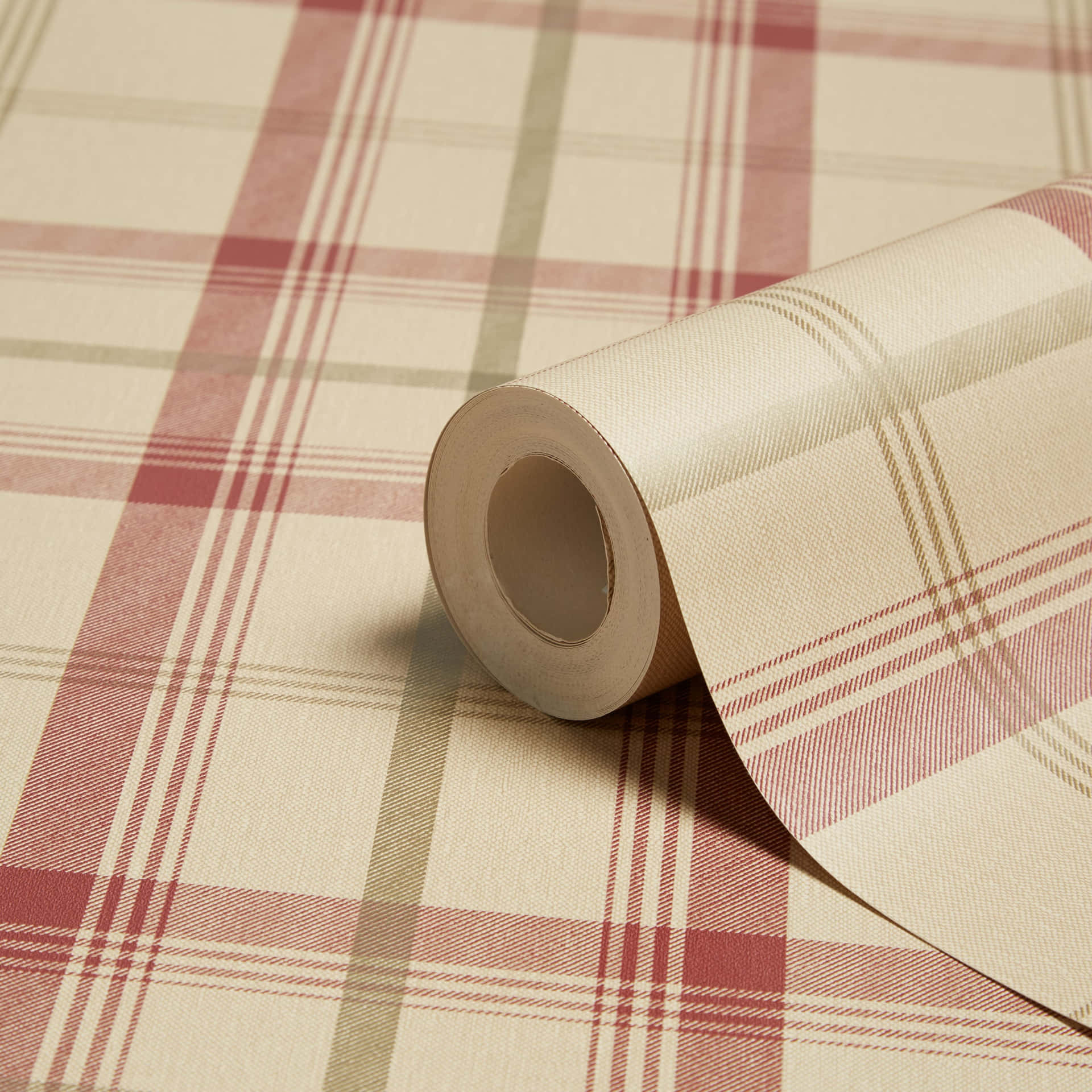 A Roll Of Plaid Wallpaper On A Table Background