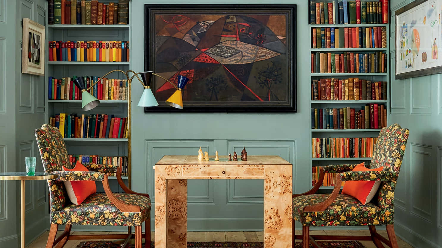 A Room With A Chess Table And Bookshelves Background