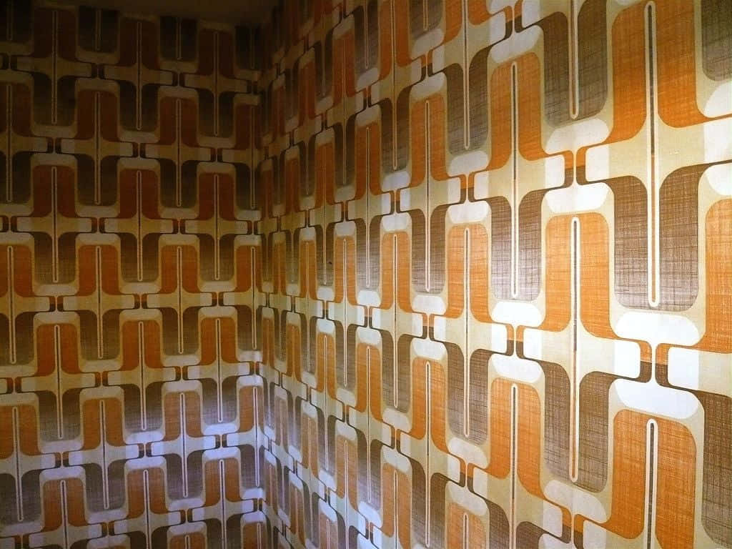 A Room With A Wall Covered In Orange And Brown Wallpaper Background