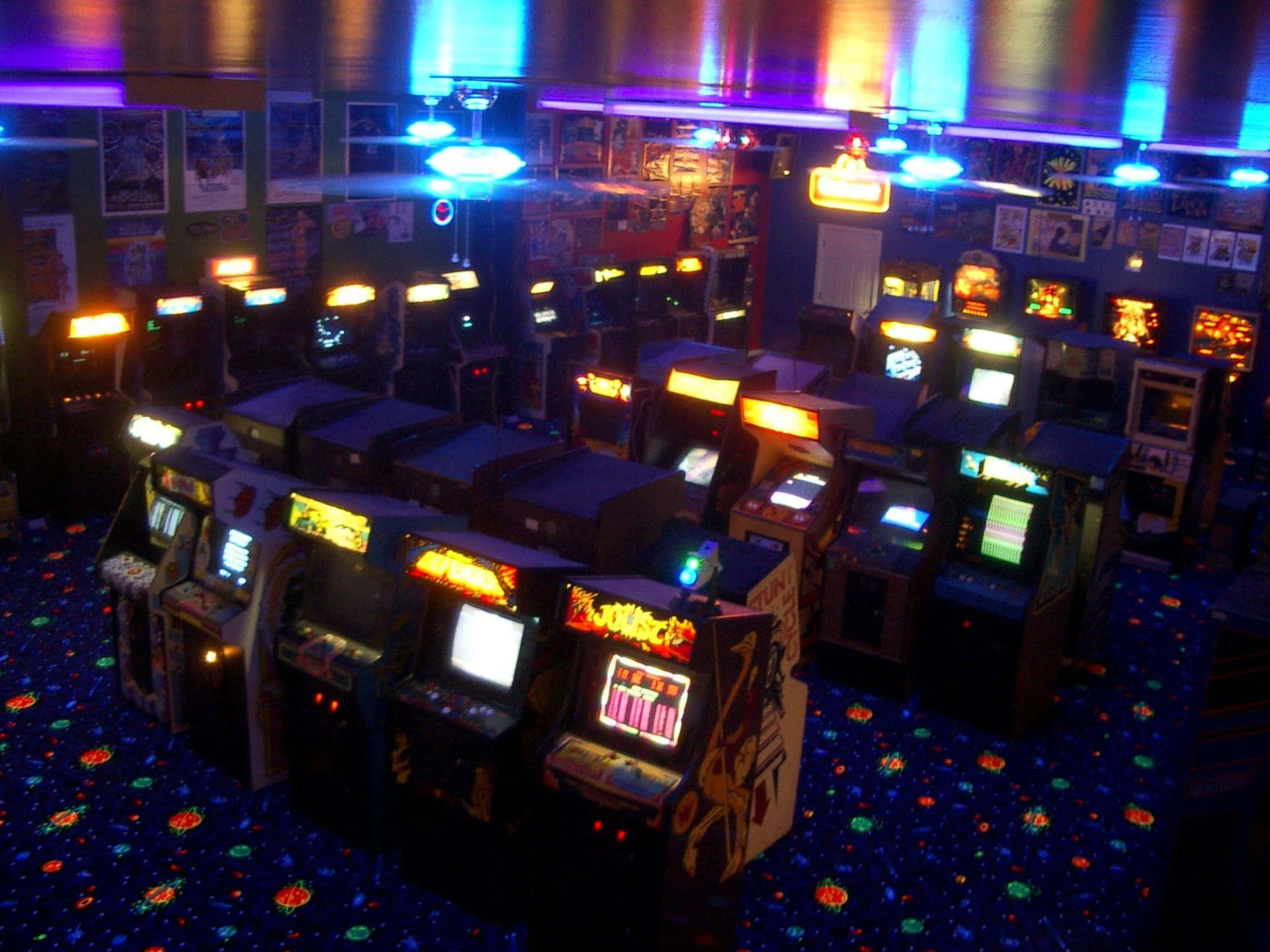 A Room With Many Video Game Machines Background