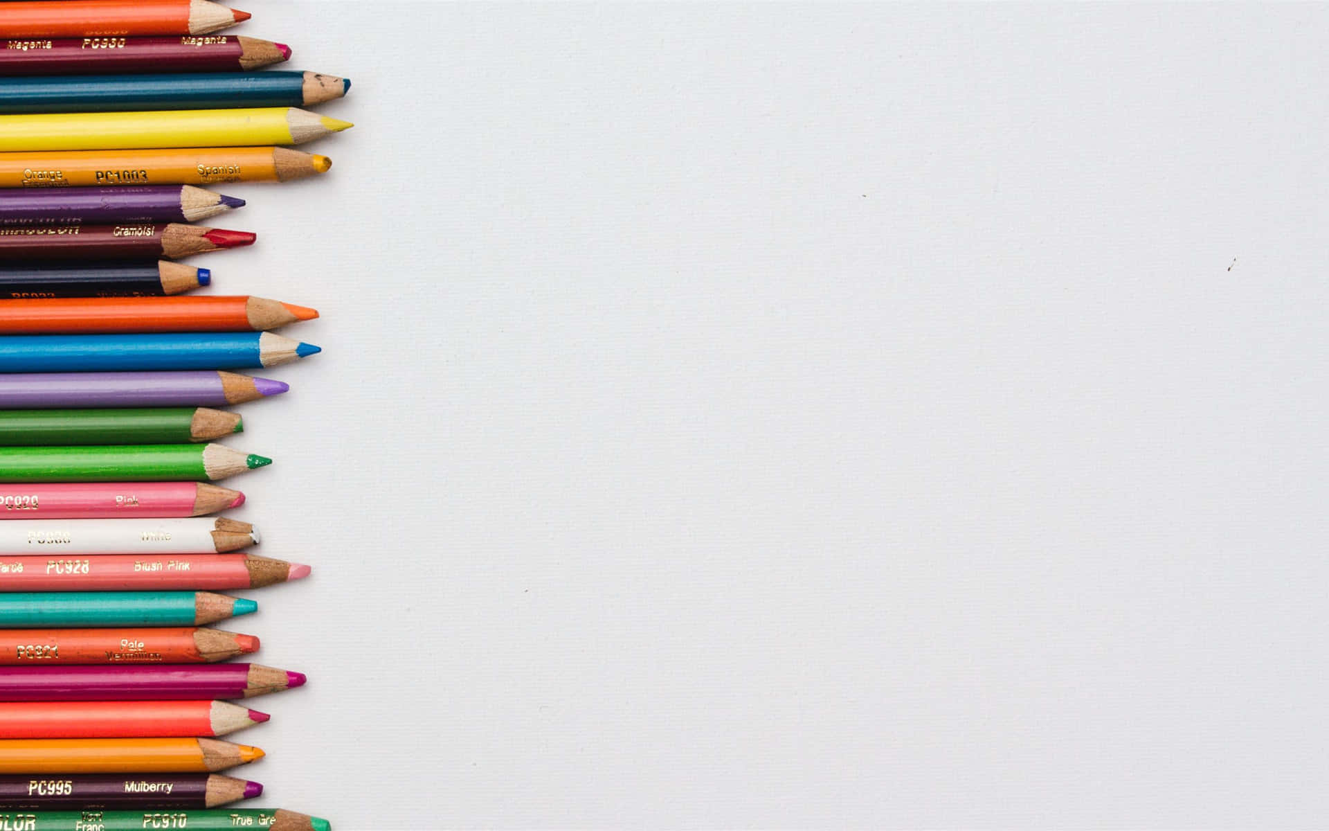 A Row Of Colored Pencils On A White Background Background