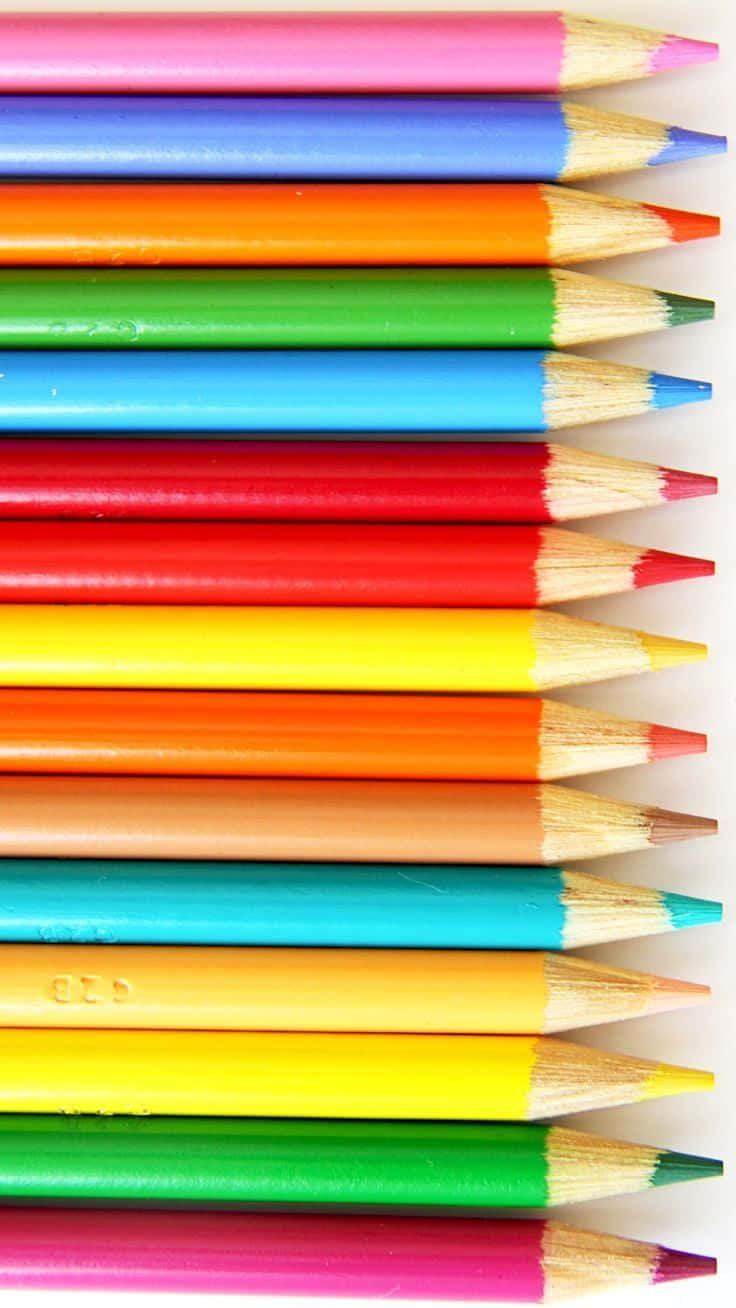A Row Of Colored Pencils On A White Background Background
