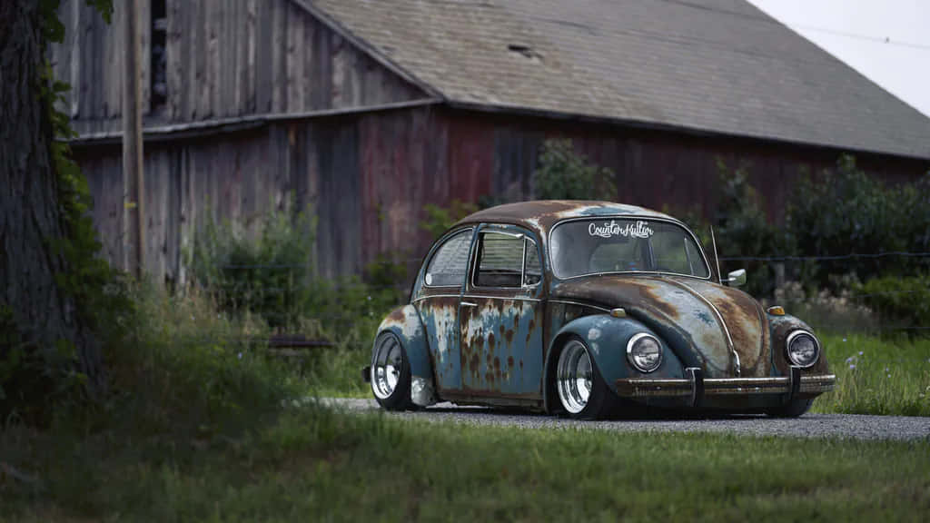 A Rusty Old Vw Beetle Sitting On A Road