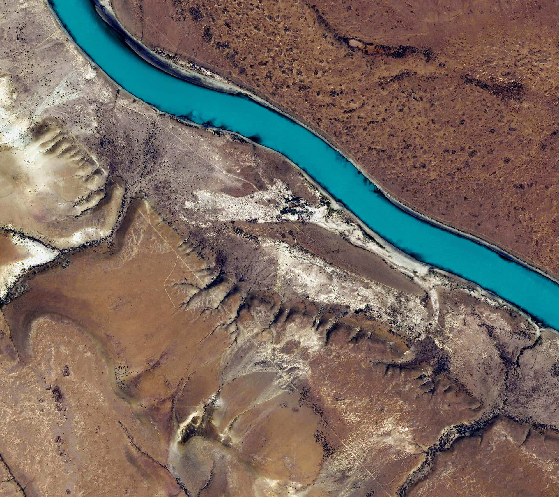 A Satellite Image Of A River In The Desert Background