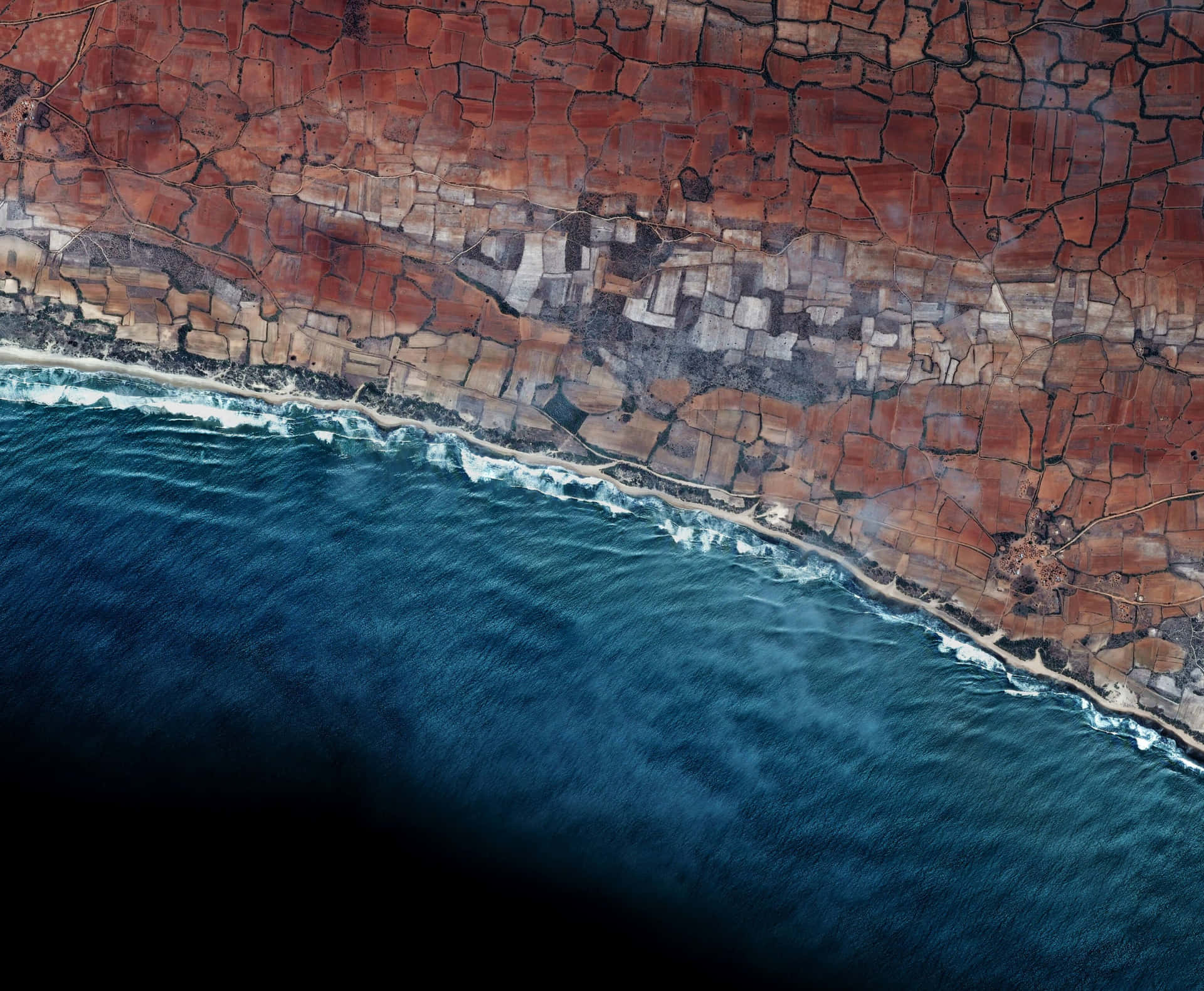 A Satellite Image Of The Ocean And Land