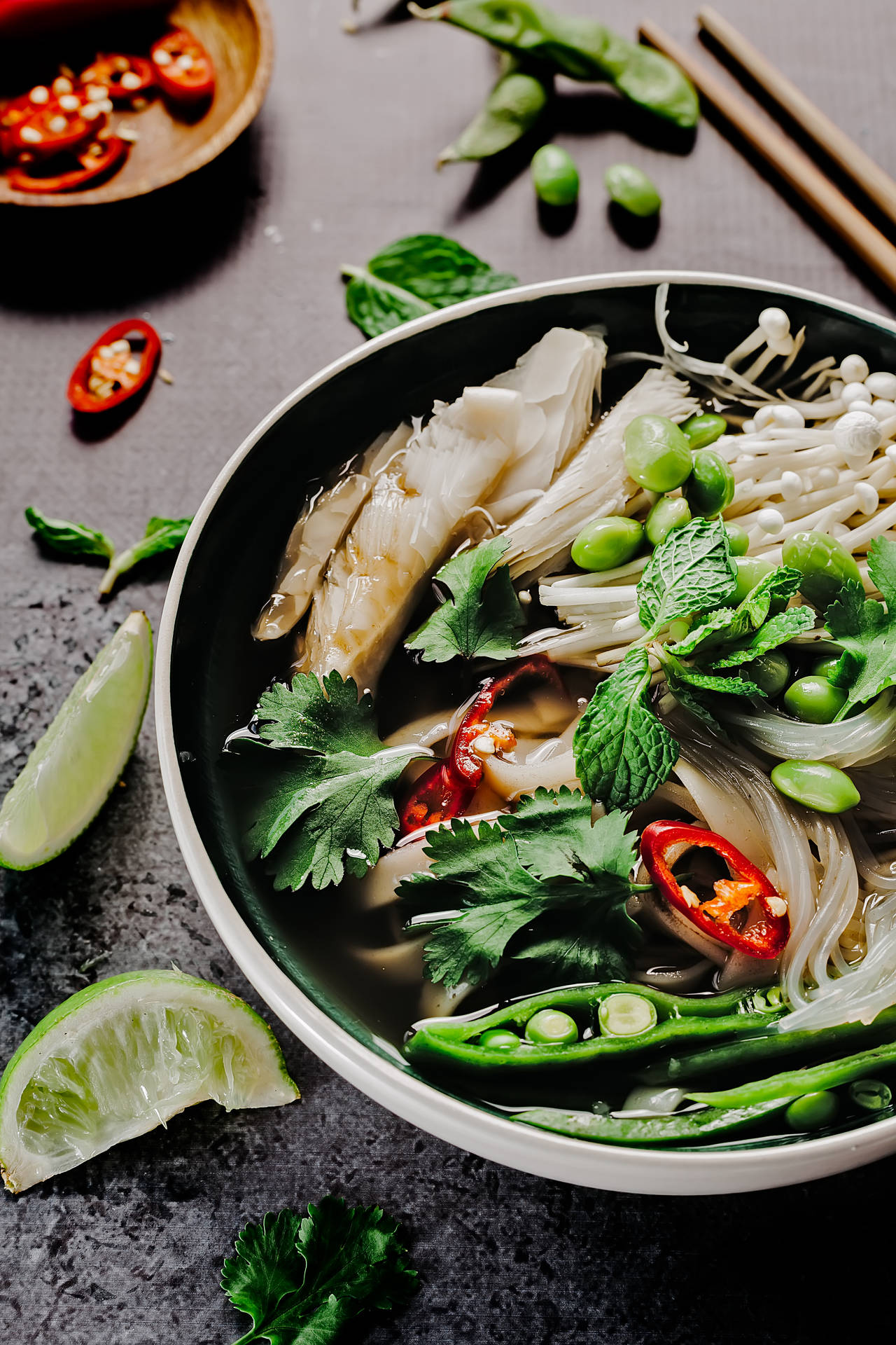 A Satisfying Bowl Of Pho: Traditional Vietnamese Noodle Soup With Fresh Vegetables. Background