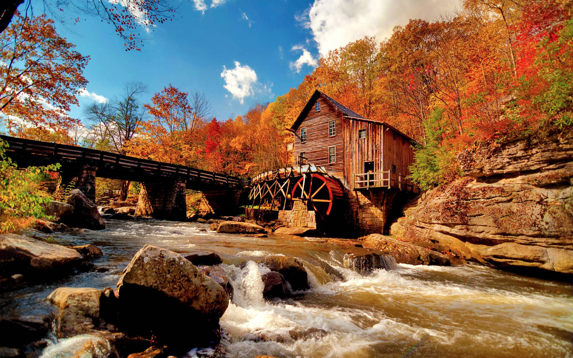 A Scenic Autumn Landscape With River And A Warm House Background