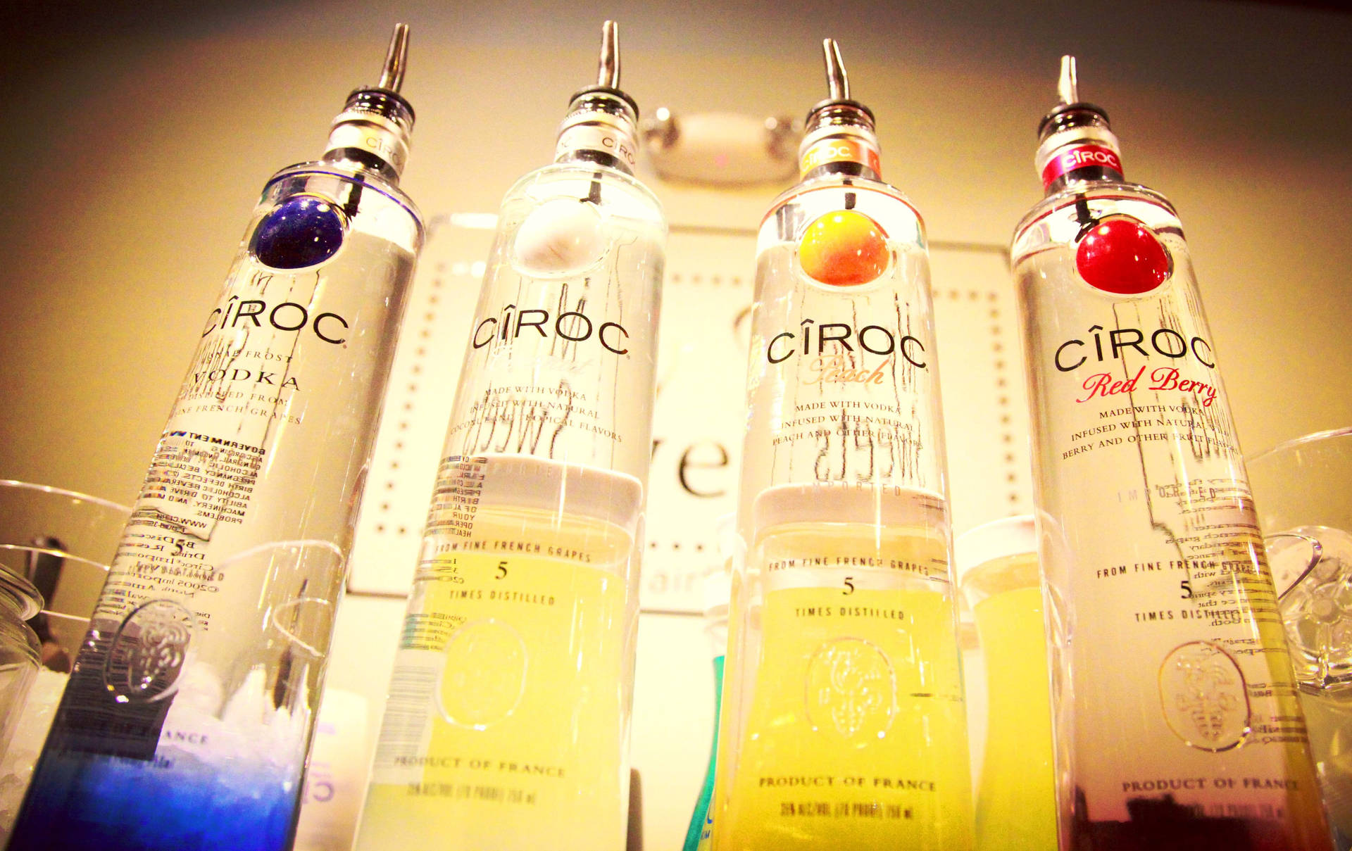 A Selection Of Ciroc French Vodka Flavors: Coconut, Peach, And Red Berry. Background