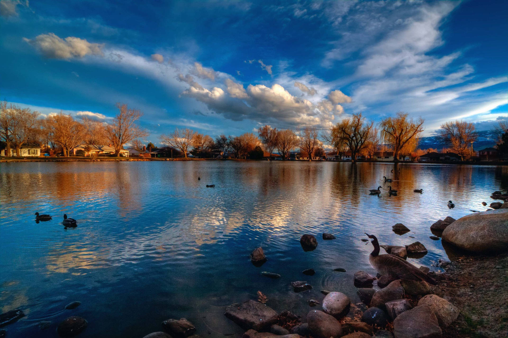 A Serene Sunrise Over Lake Reno Background