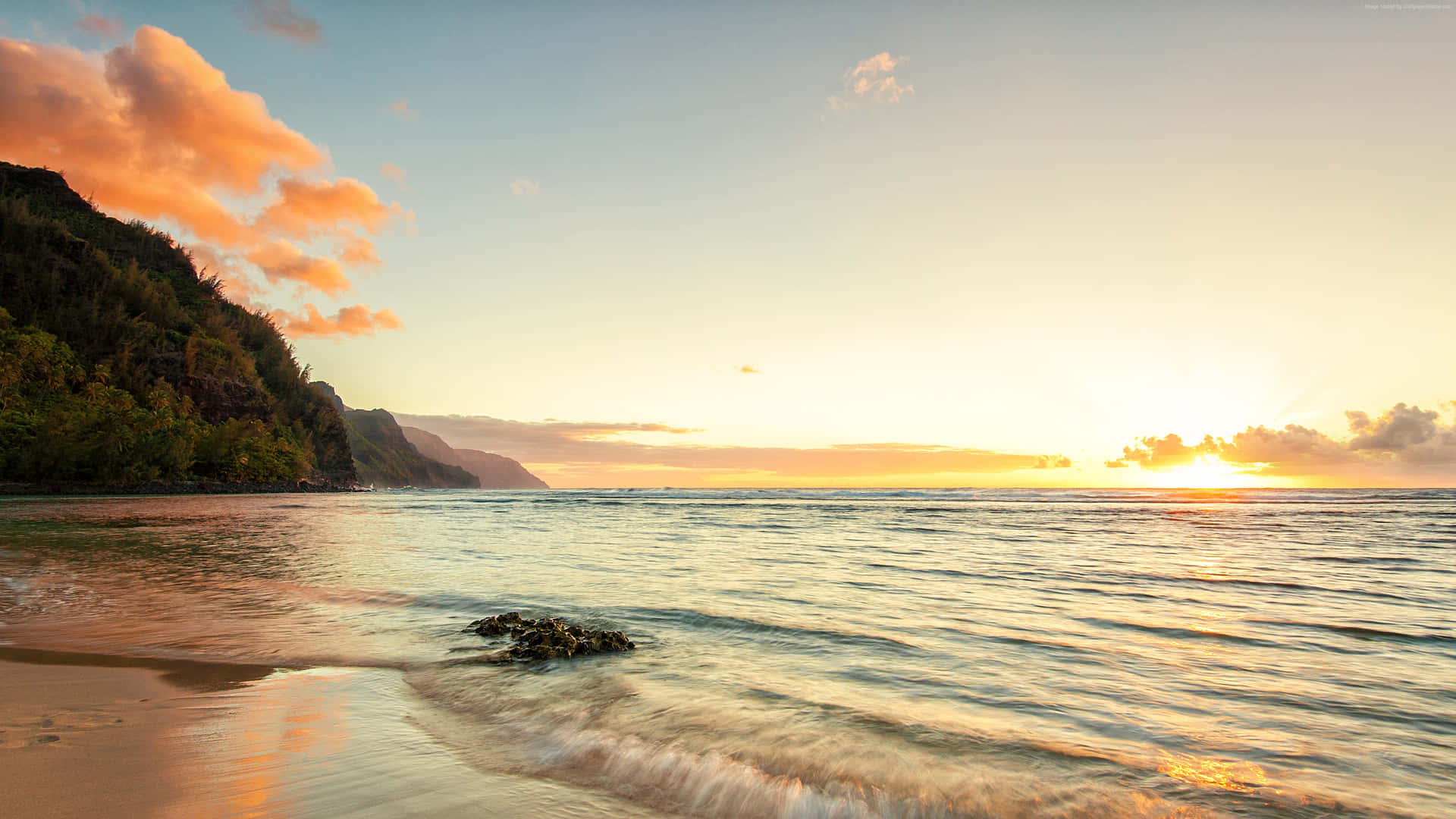 A Serene Sunrise Over Ocean Beach Background