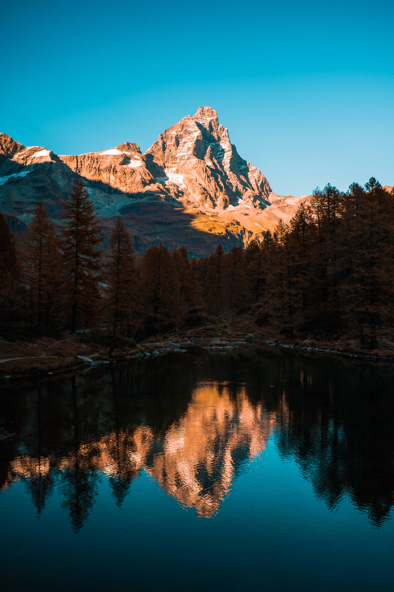A Serene View Of A Mountain And Lake Background