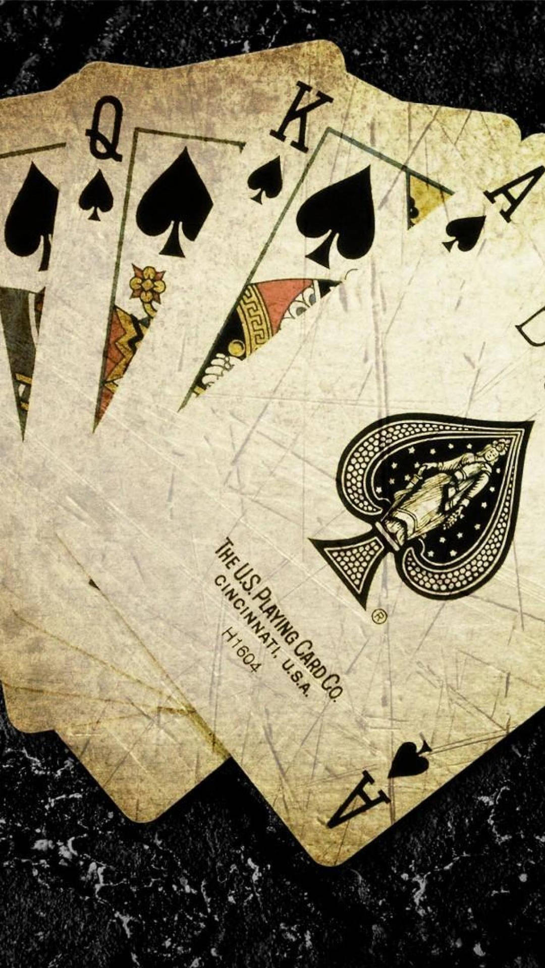 A Set Of Playing Cards On A Black Surface Background