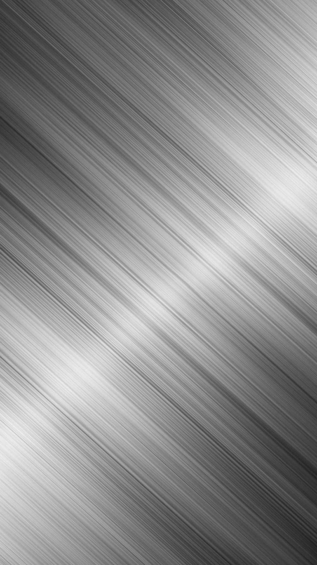 A Shiny Black Metallic Surface Reflects On A Brightly Lit Room Background
