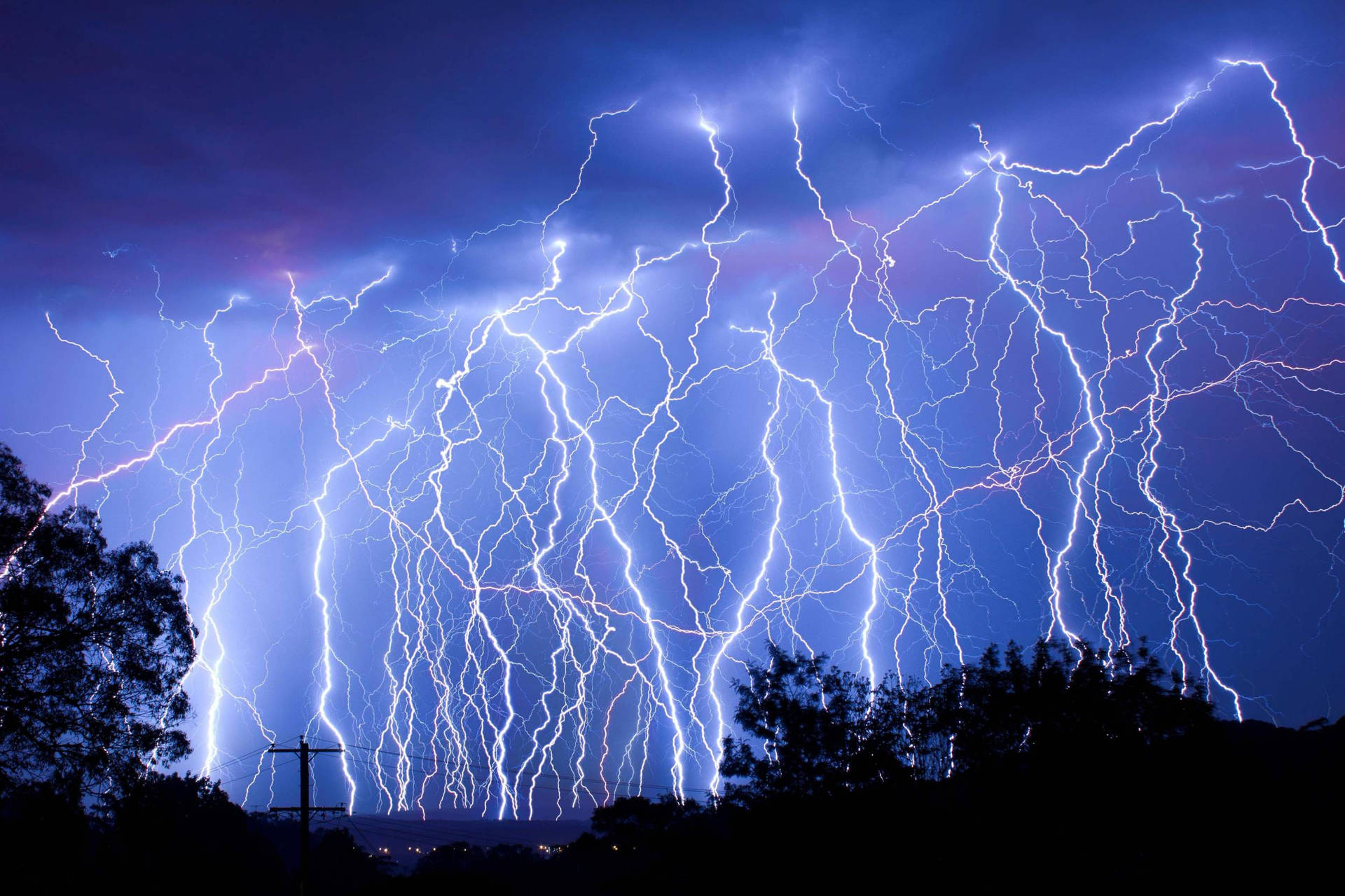 A Shot Of An Eye-catching Lightning Strike In A Night Sky Background