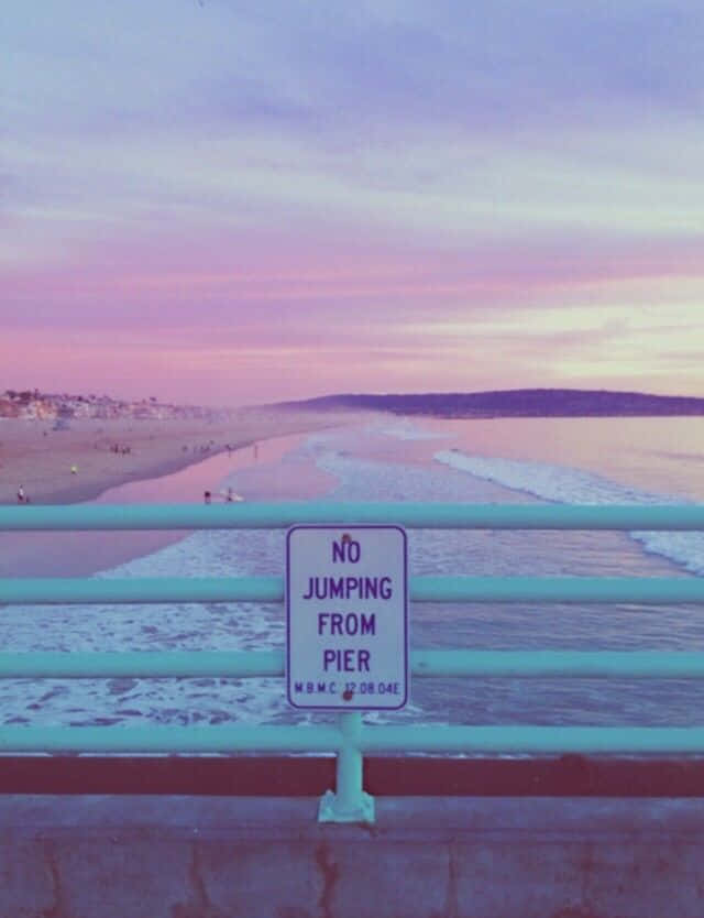 A Sign That Says No Jumping Off The Pier Background