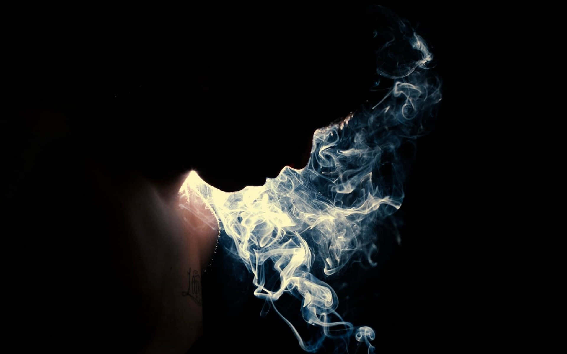 A Silhouette Of A Person With Smoke Coming Out Of His Mouth Background