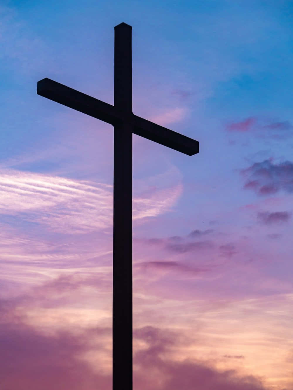 A Silhouette Of A White Cross On A Pink Background.