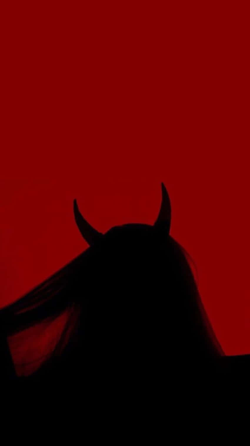 A Silhouette Of A Woman With Horns In Front Of A Red Background Background