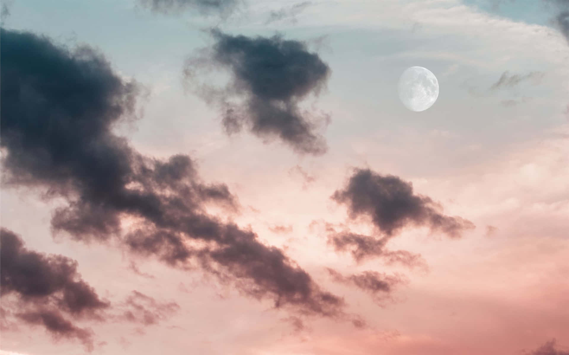 A Silhouetted Landscape Lit Up By A Pink Full Moon Background