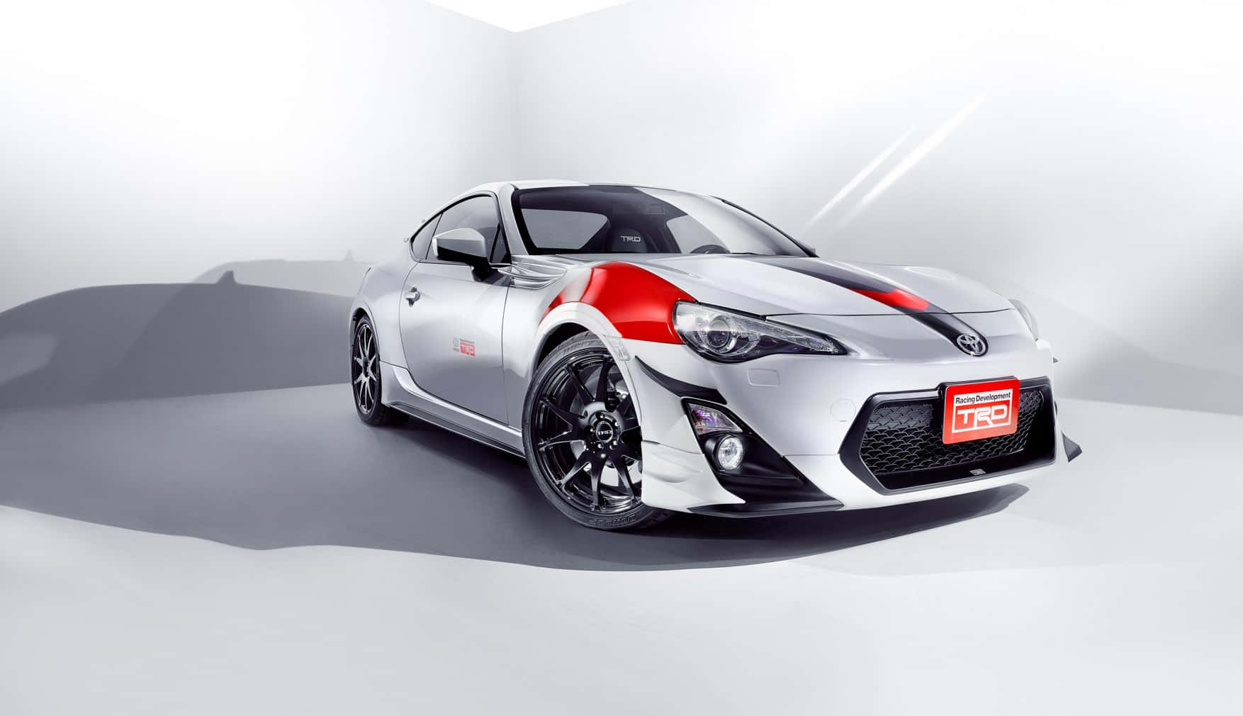 A Silver And Red Sports Car Is Shown In A Studio Background