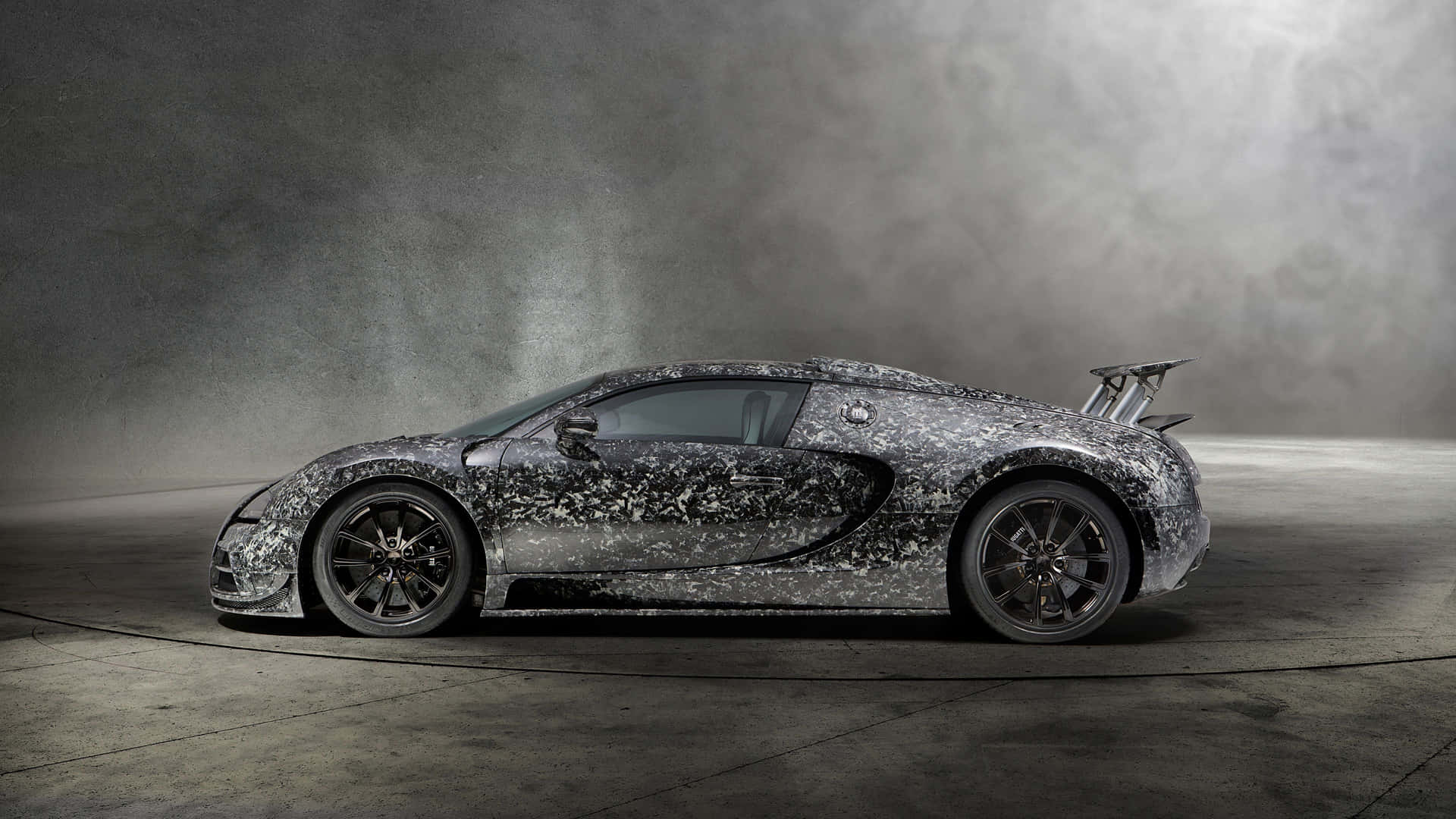 A Silver Bugatti Veyron C7 Sat In A Dark Room Background