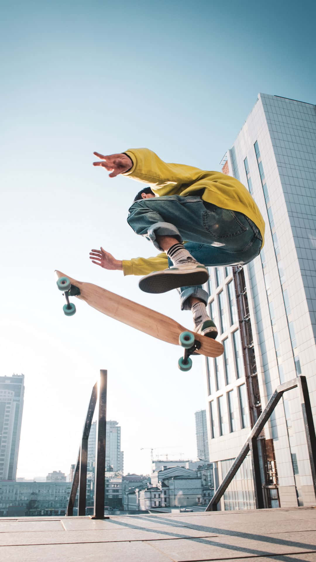 A Skateboarder Doing Tricks In The Air Background