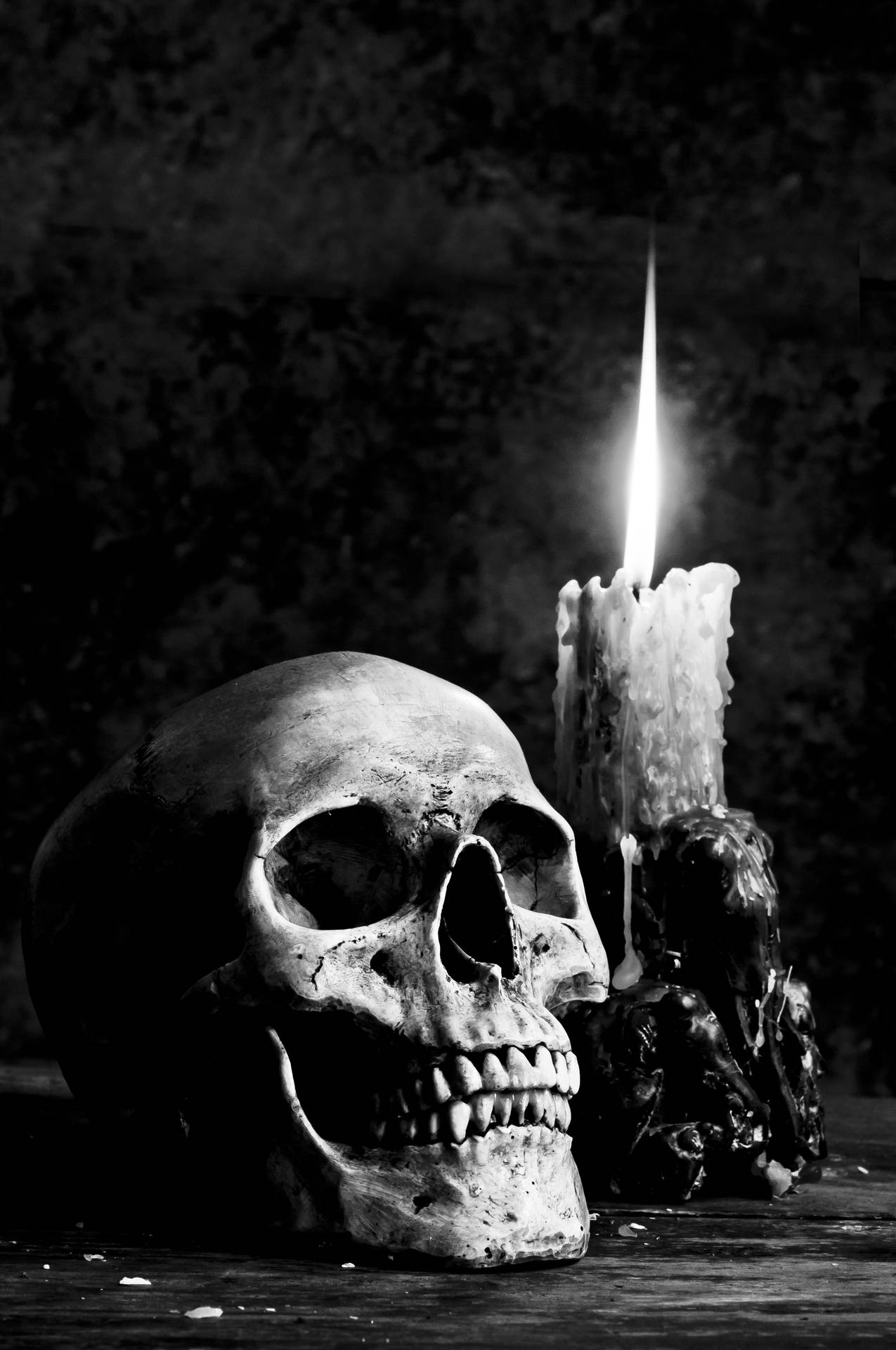 A Skull And Candle On A Table