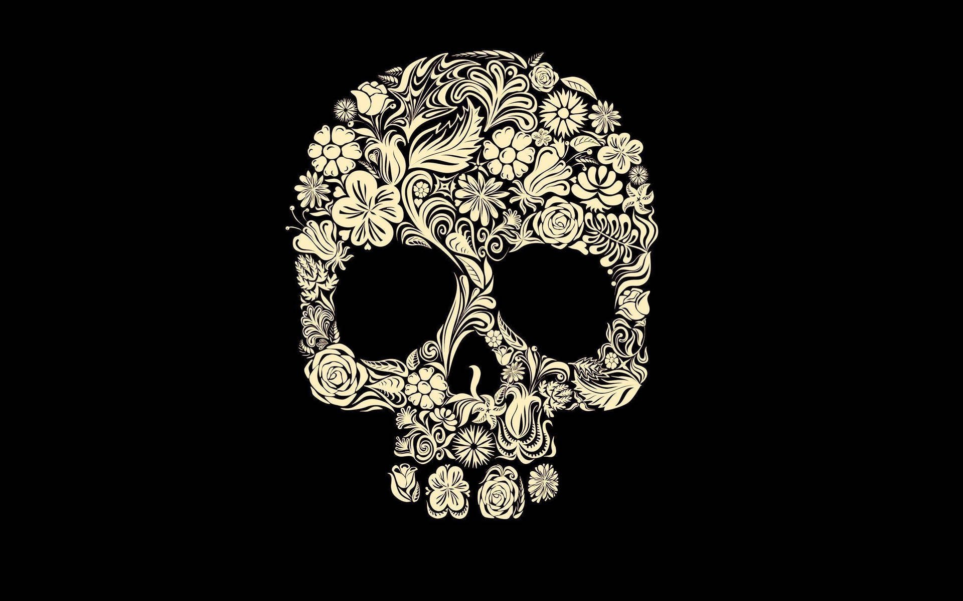 A Skull With Floral Designs On A Black Background