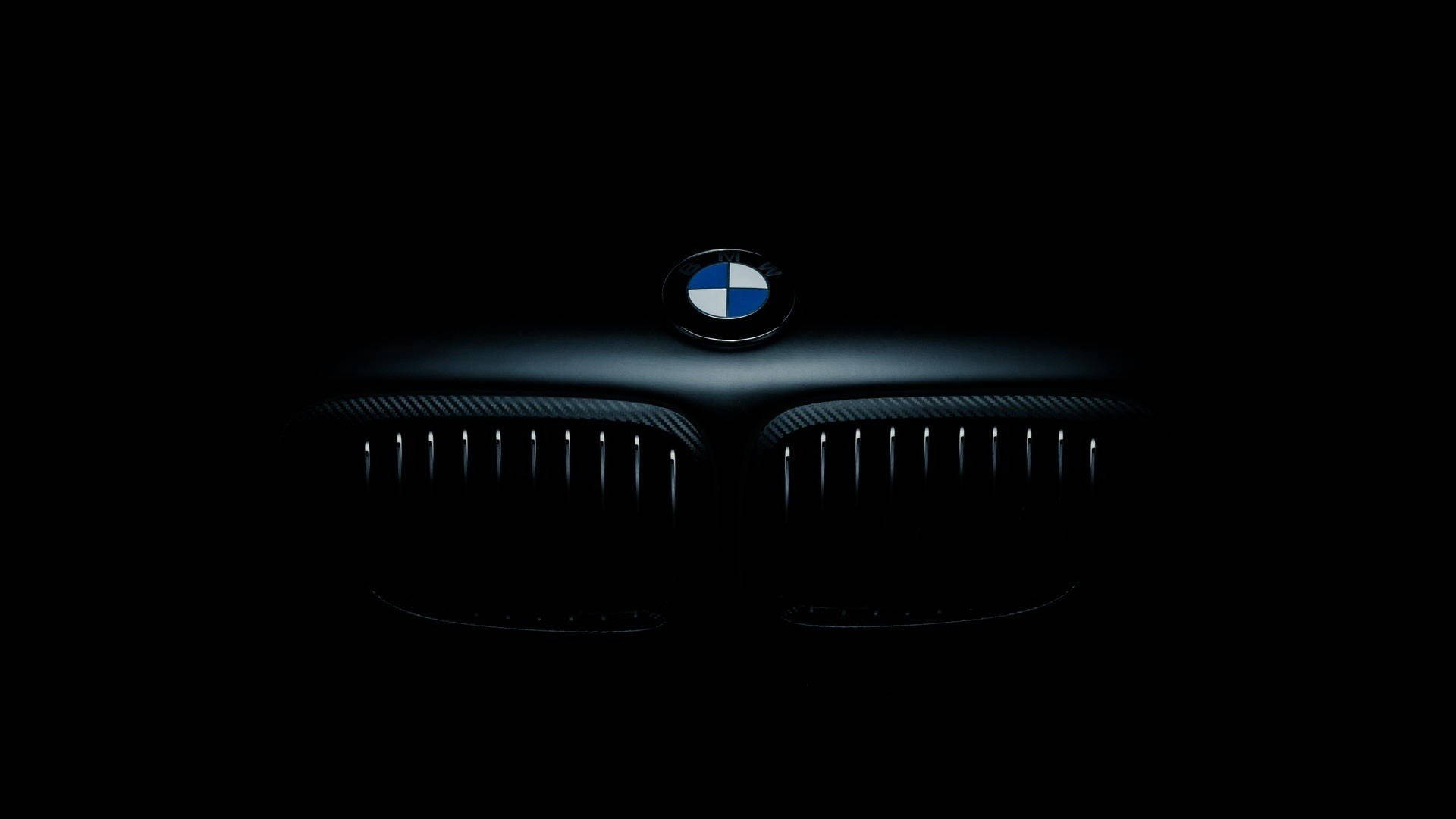 A Sleek, Black Bmw On Display In A Clean, Modern Setting. Background