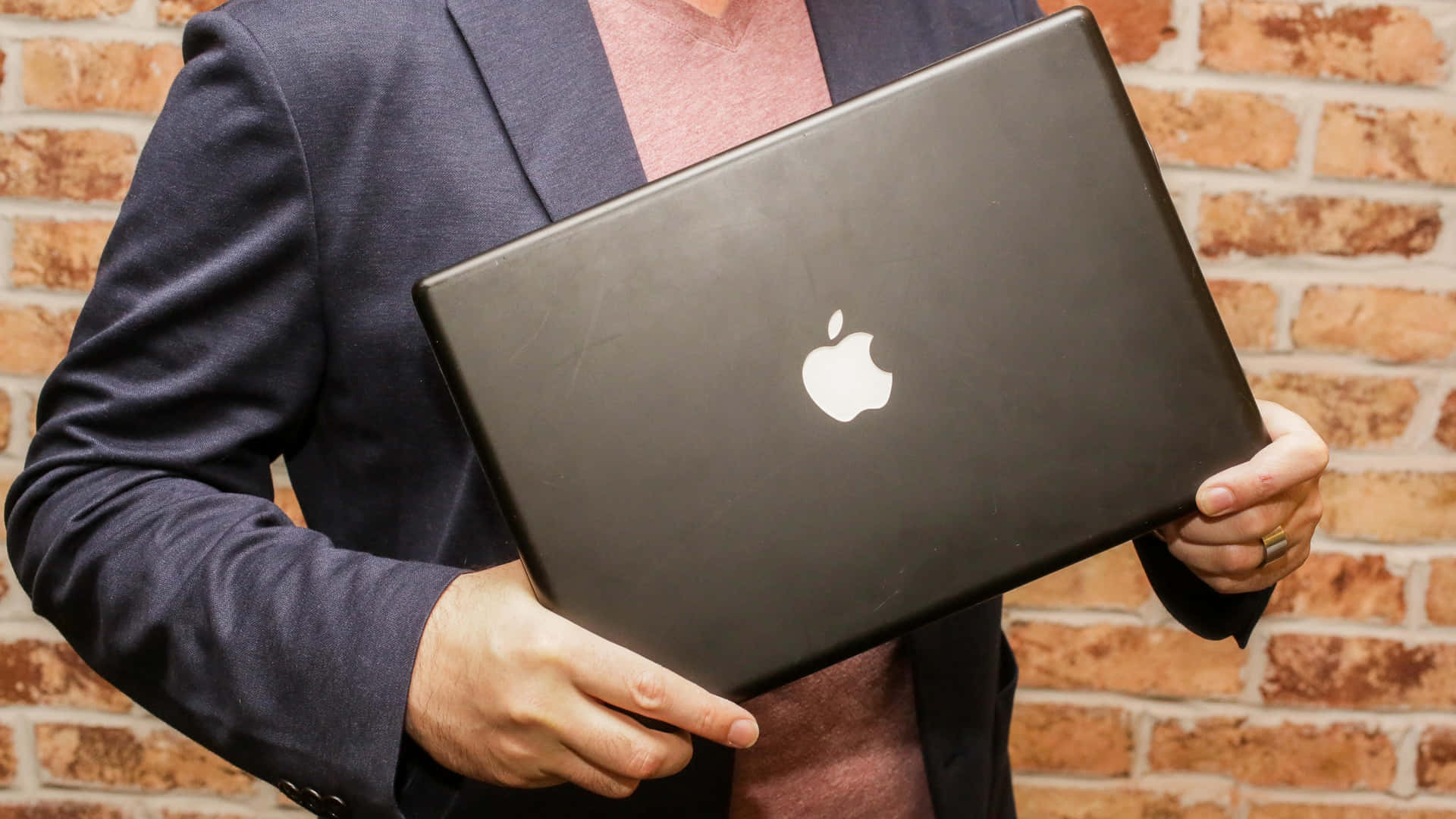 A Sleek Black Macbook For The Modern User Background