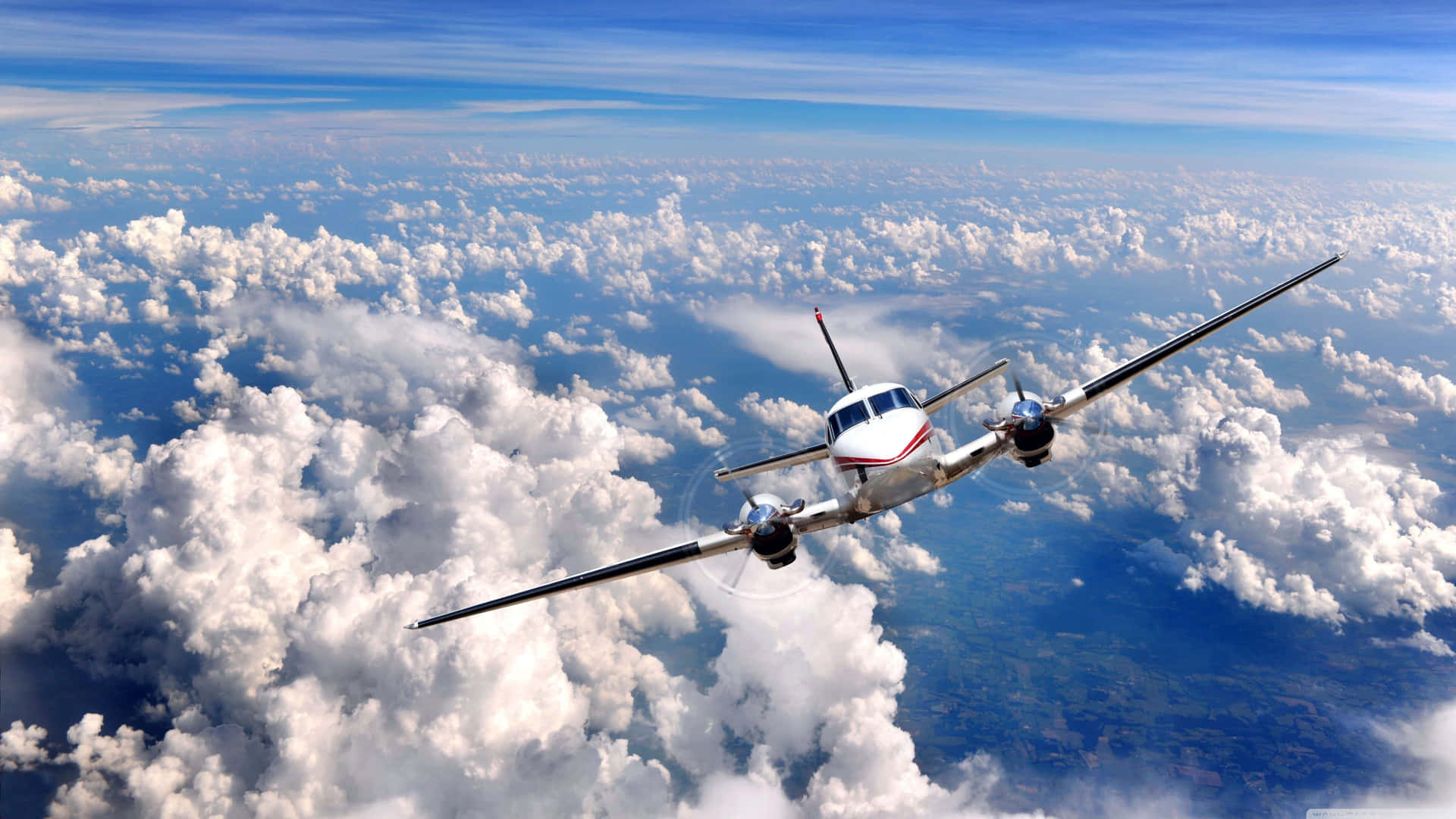 A Small Airplane Flying Through The Clouds Background