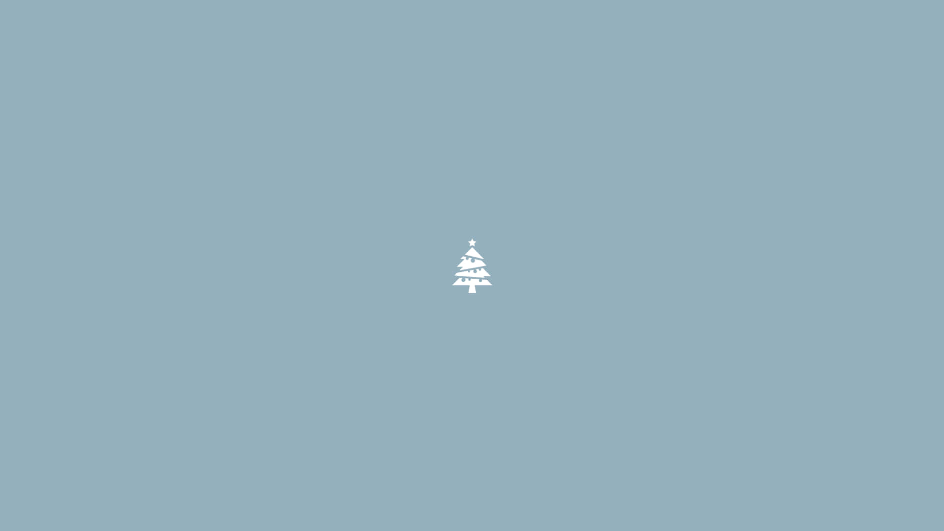 A Small Christmas Tree On A Blue Background