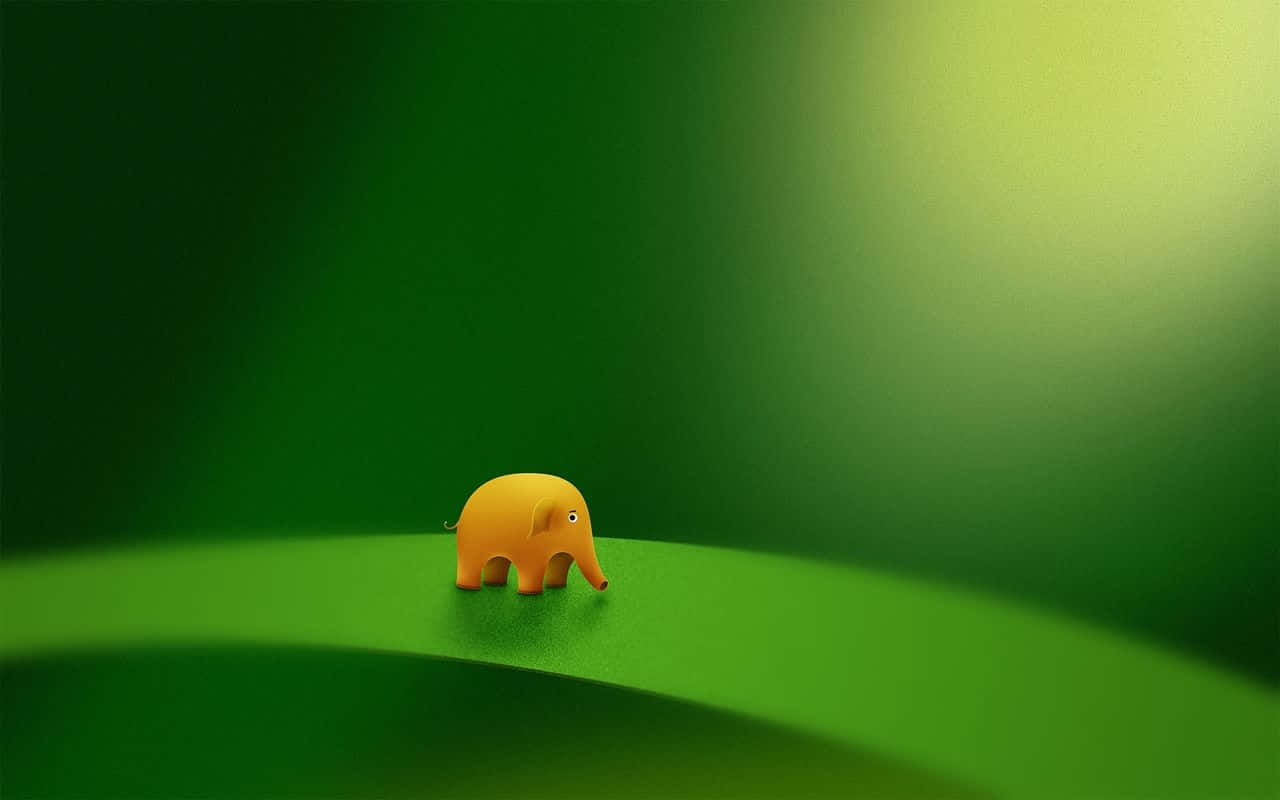 A Small Yellow Elephant Standing On A Green Leaf Background