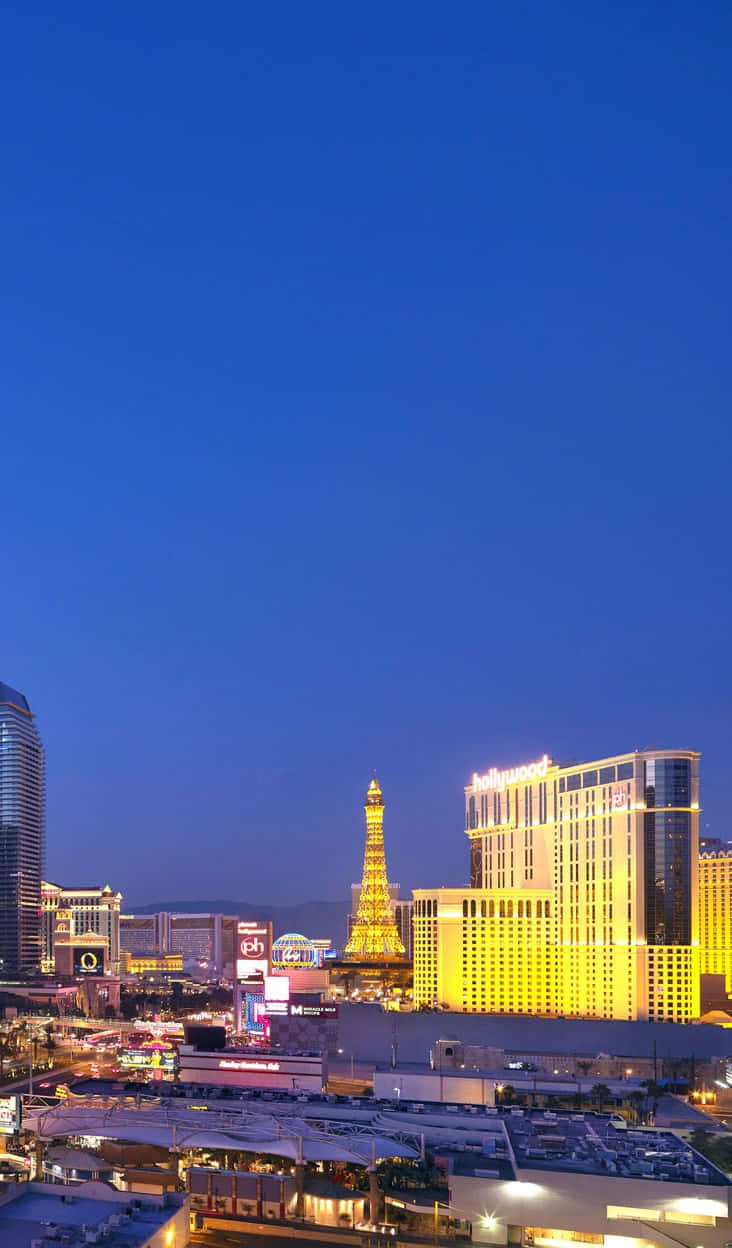 A Smartphone In Front Of The Stunning Las Vegas Skyline Background