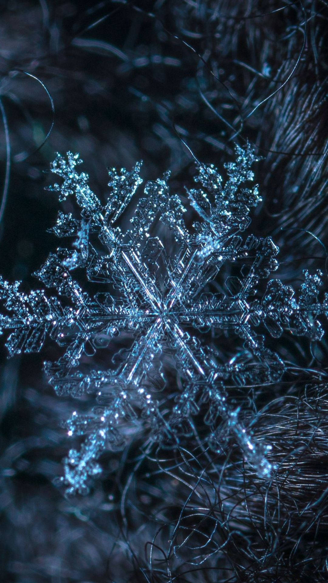 A Snowflake Is Shown In The Dark Background