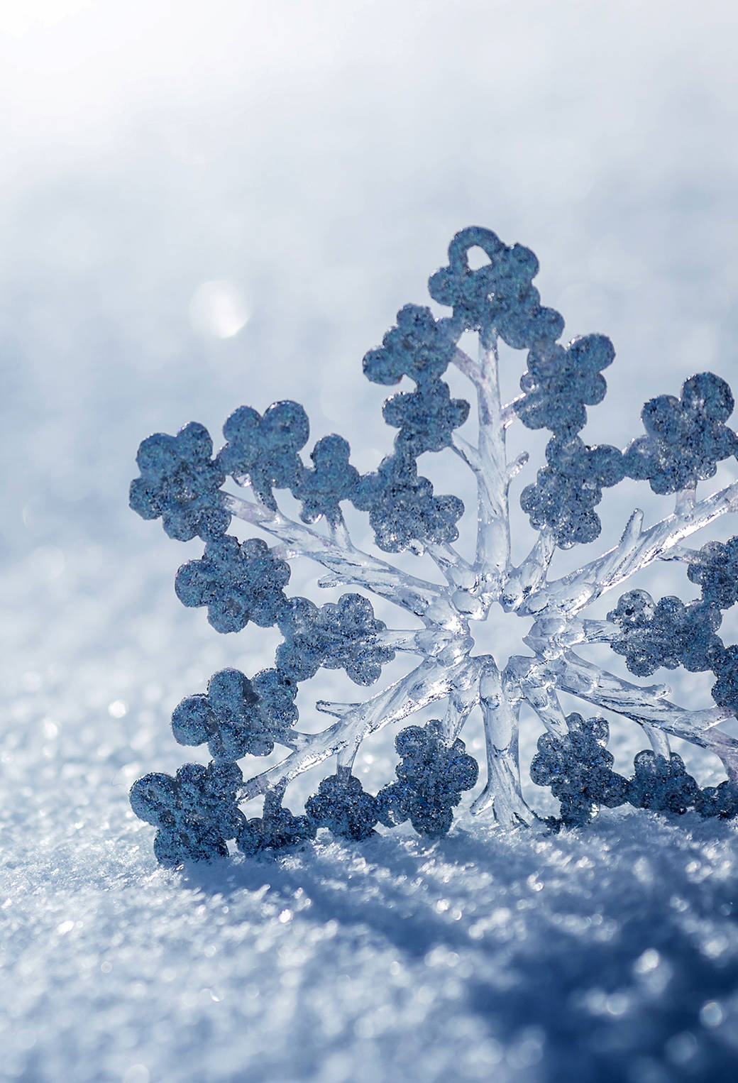 A Snowflake Is Sitting On Top Of The Snow Background