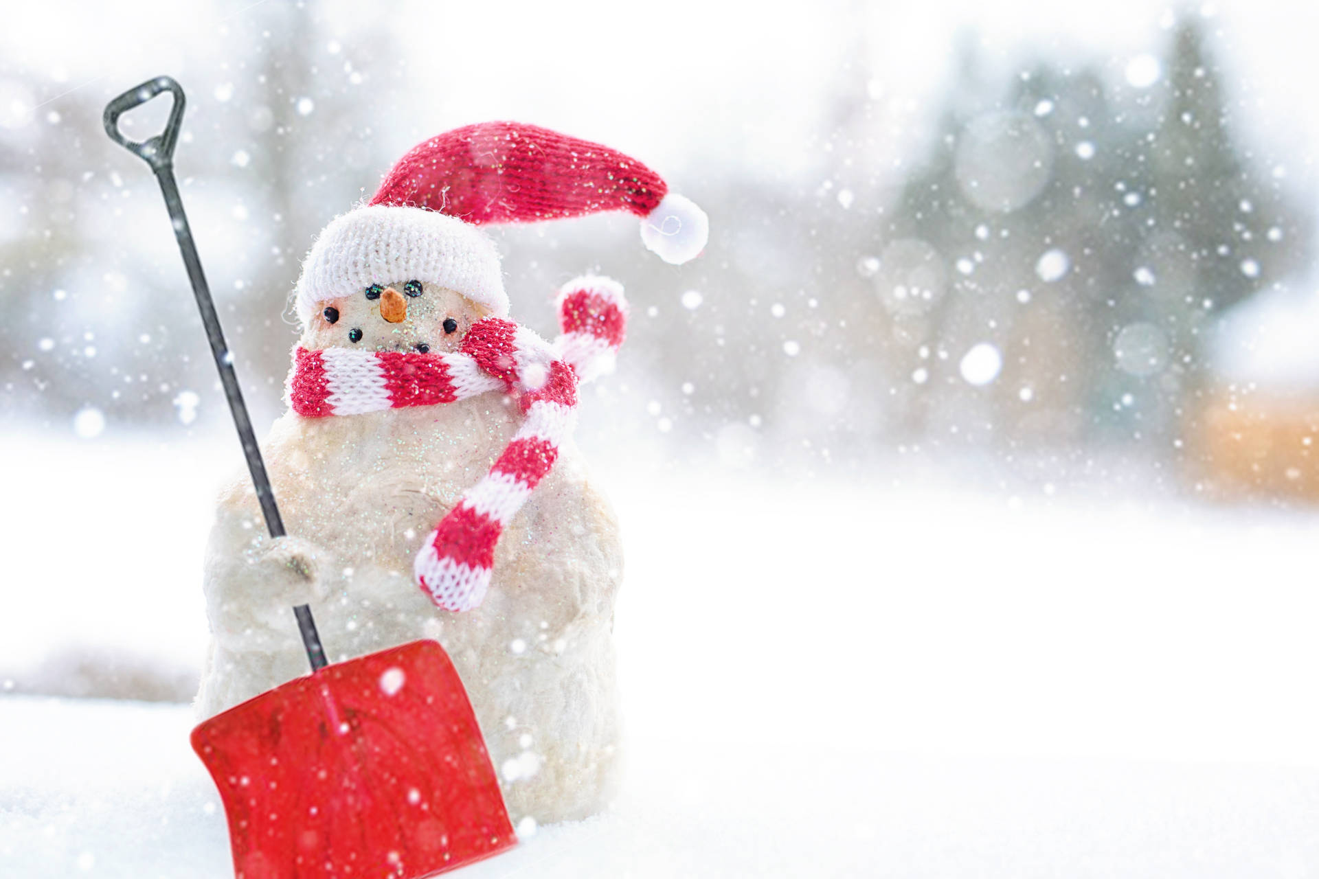 A Snowman With A Shovel In The Snow Background