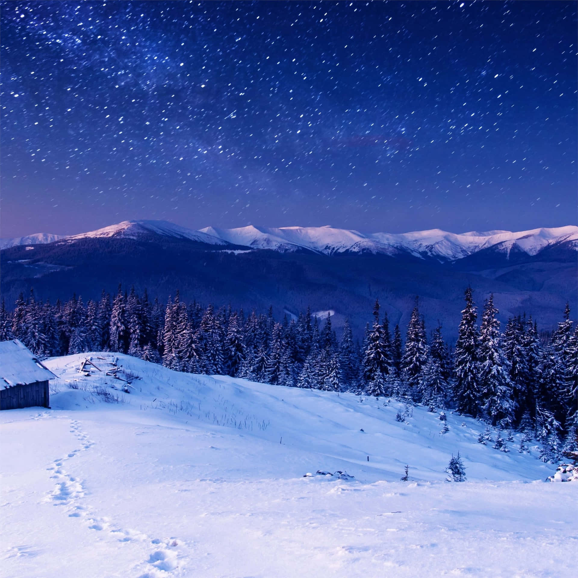 A Snowy Landscape With A Cabin And Stars Background