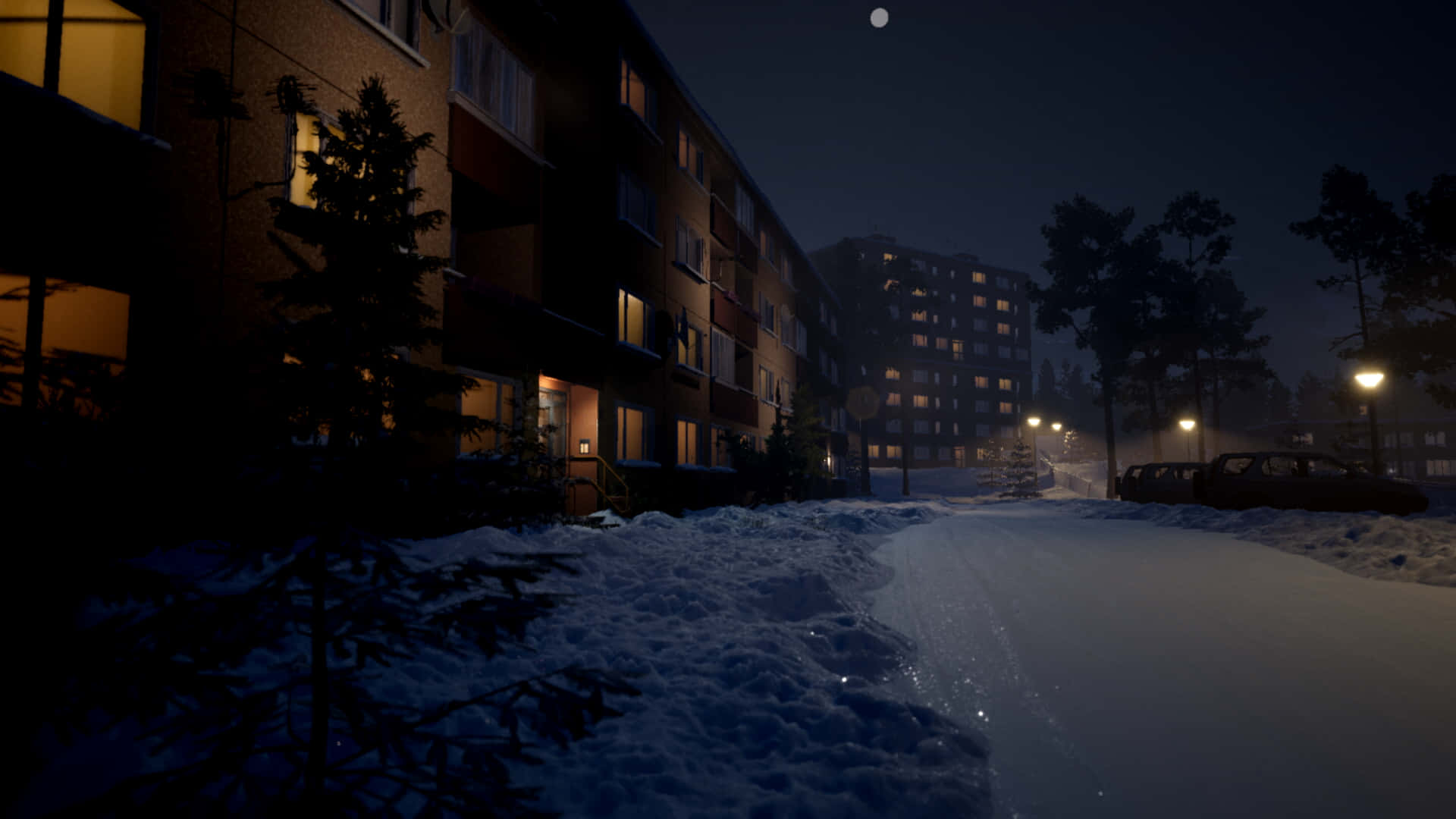 A Snowy Street With Buildings And Lights At Night Background
