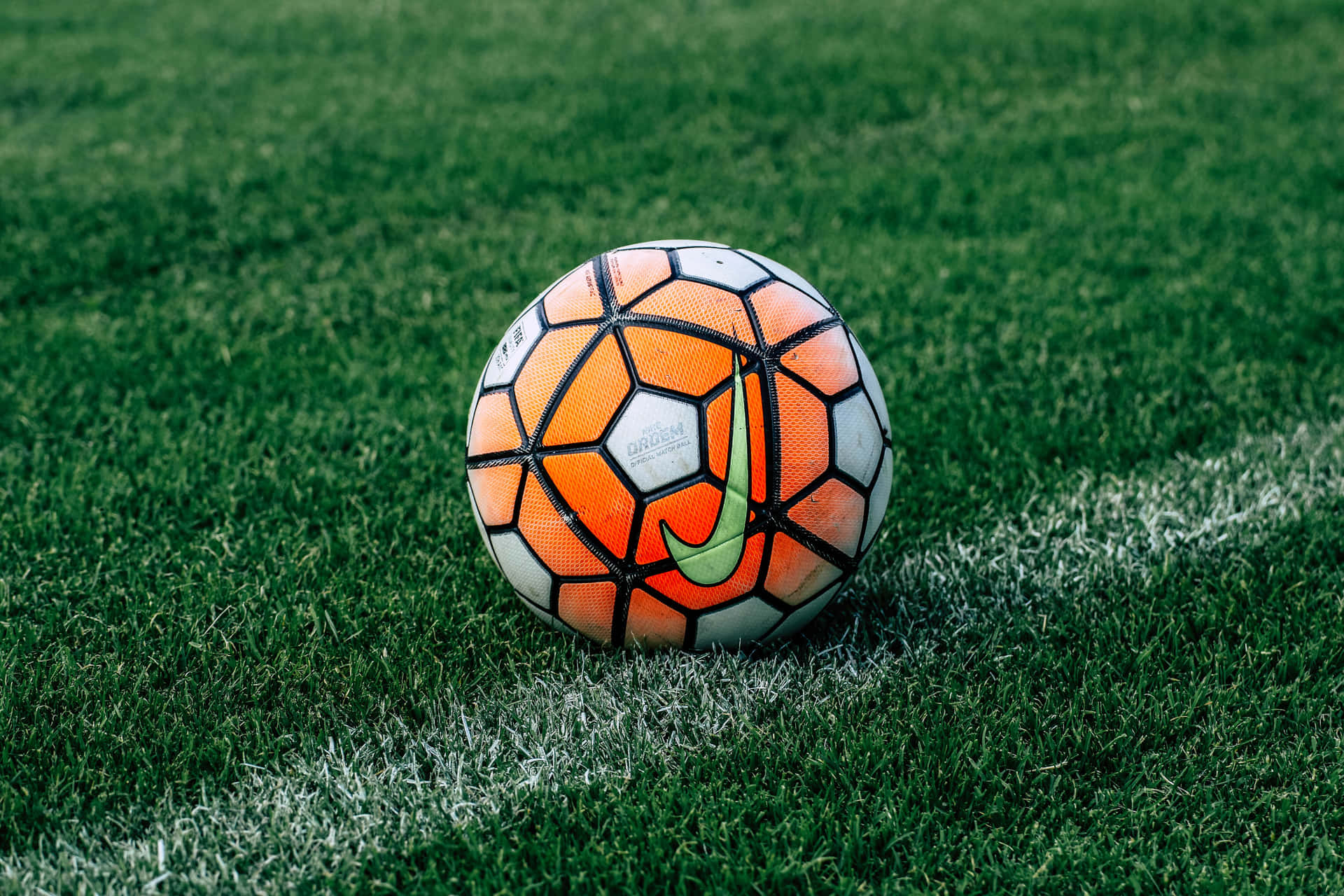 A Soccer Ball On A Green Field Background