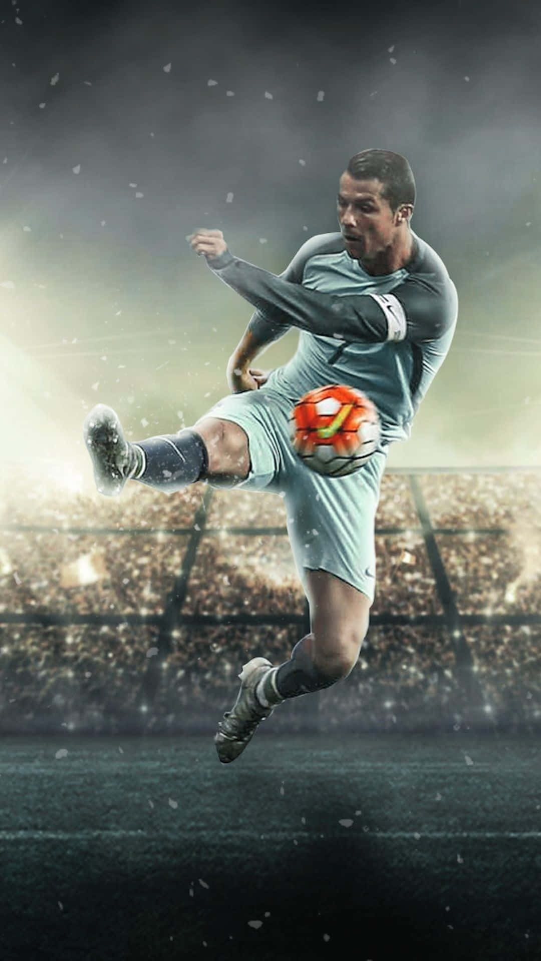 A Soccer Player Kicking A Ball In The Air Background