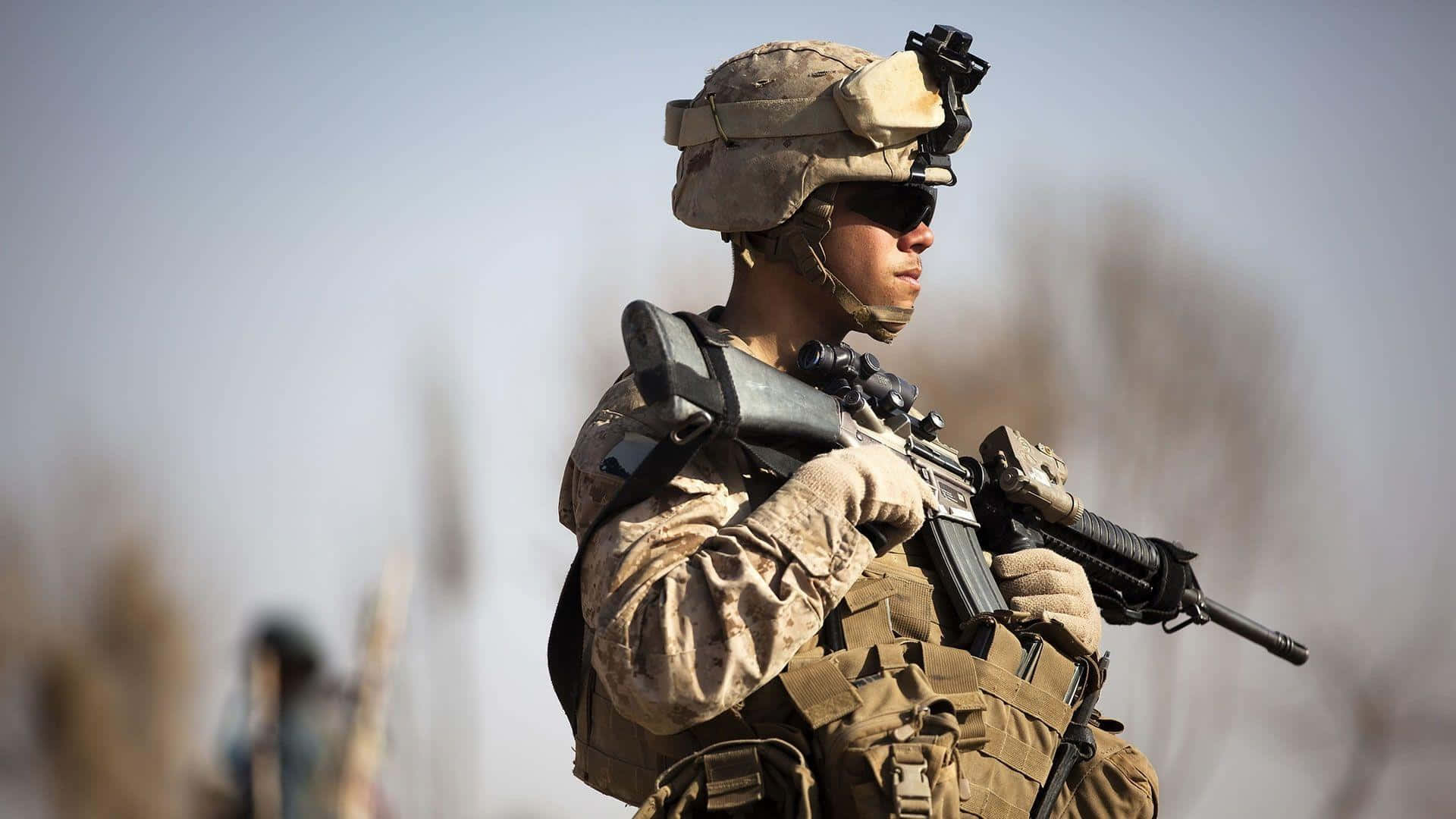 A Soldier In Uniform Is Holding An Ax Background