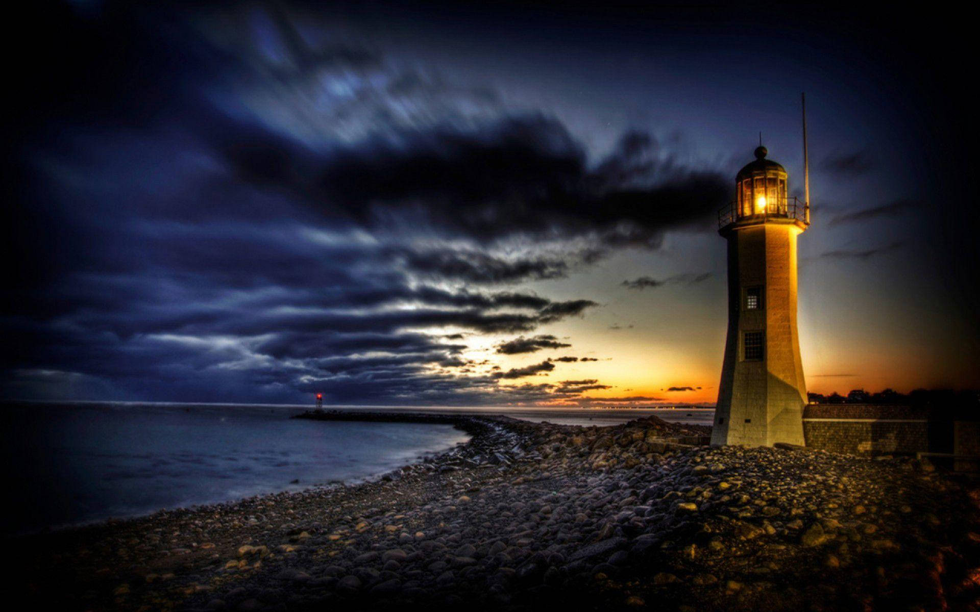 A Solitary Lighthouse Guiding The Way Background