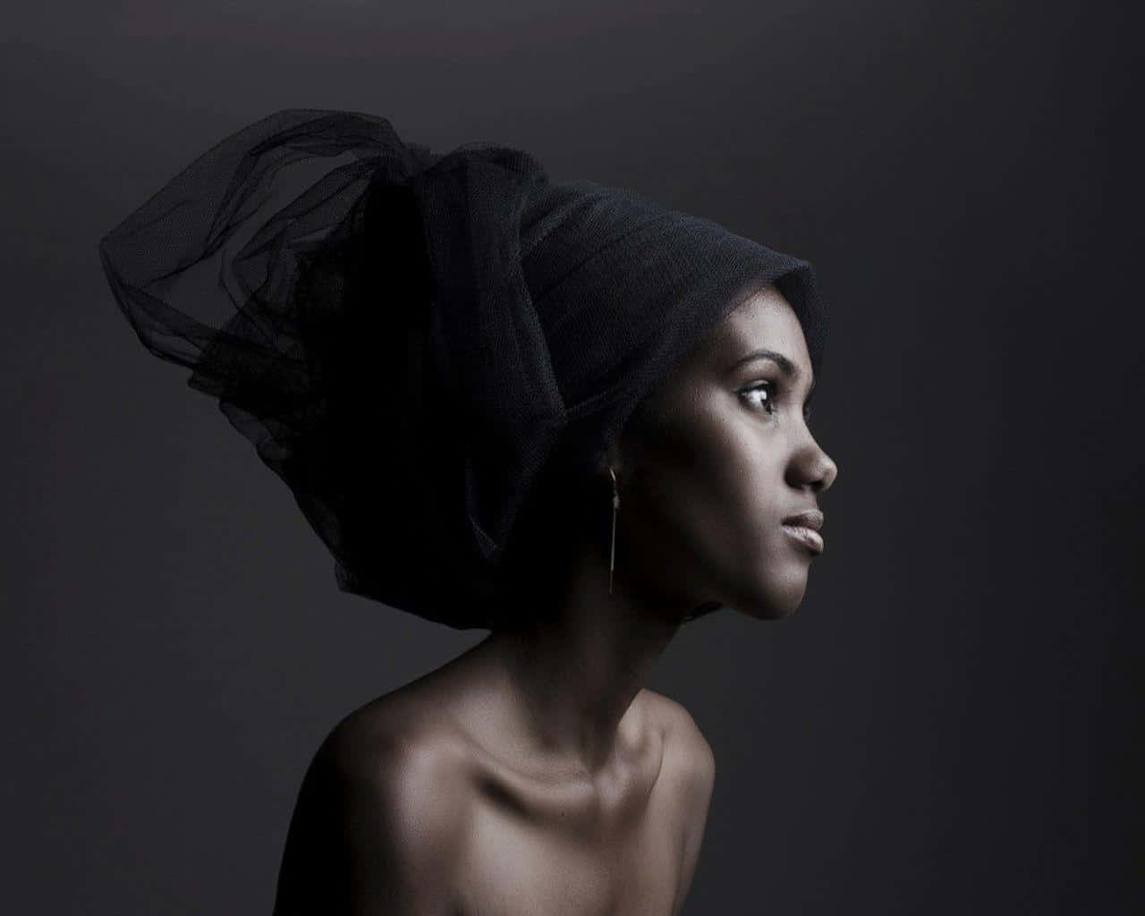 A South African Woman In Traditional Black Head Wrap Exhibiting Cultural Pride Background